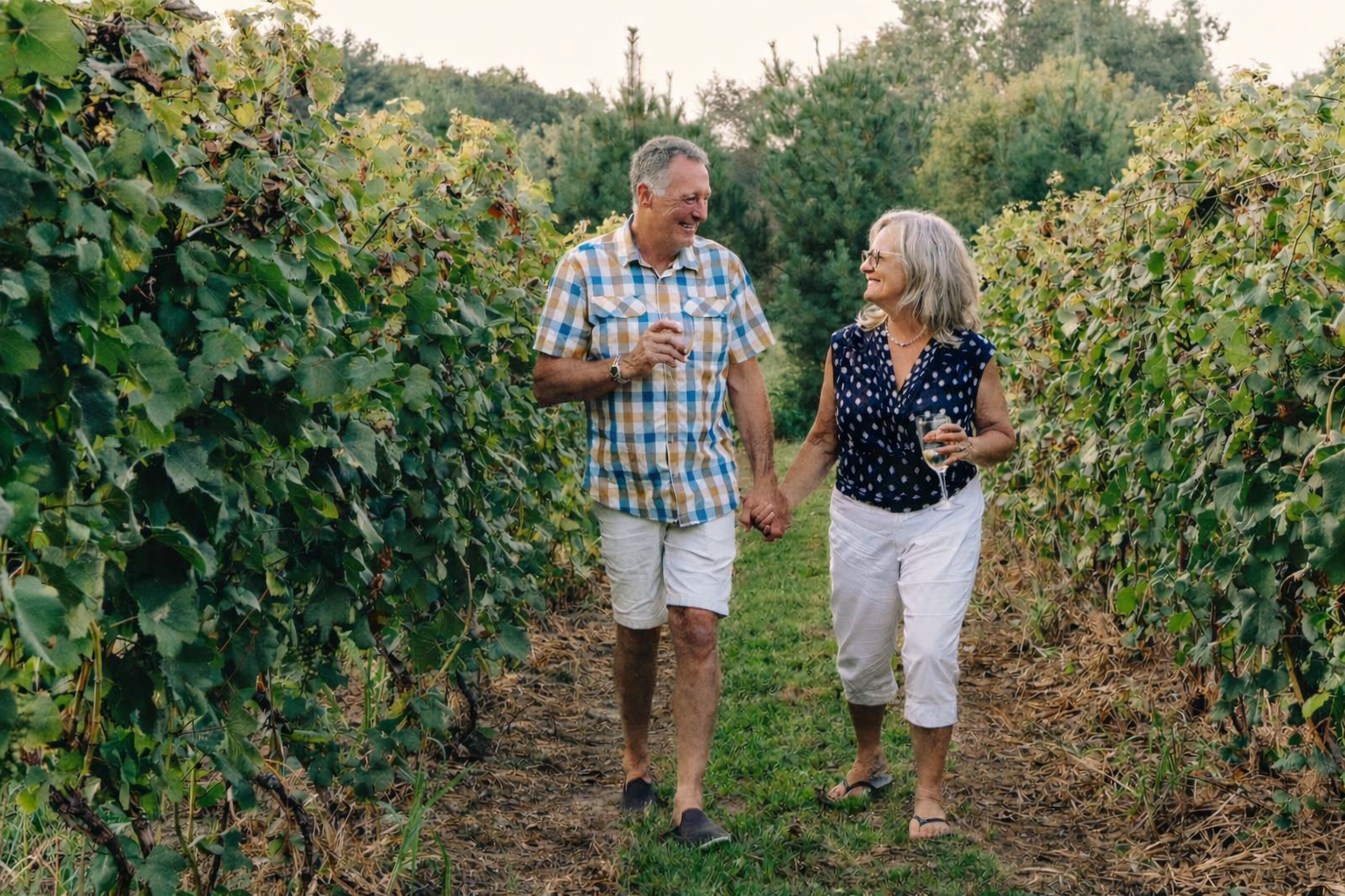 Founders of Mahan Family Wines walking through their vineyard, inviting visitors to travel to wine country and experience the estate