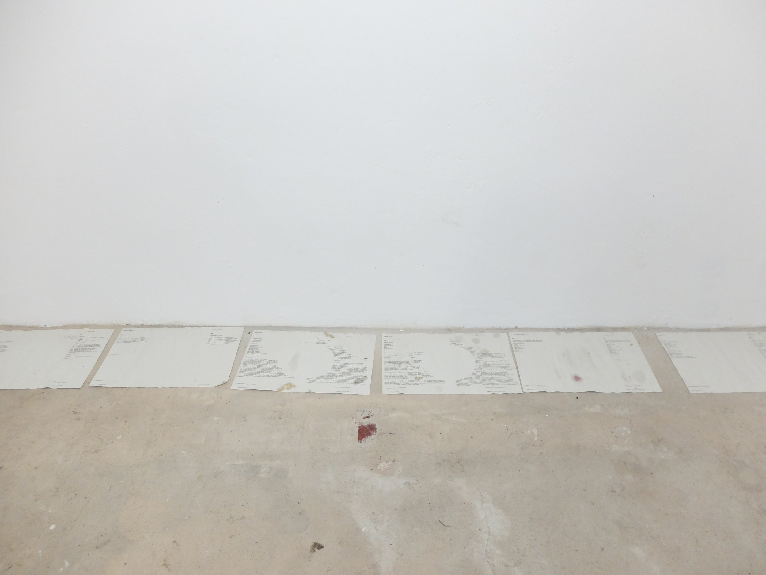   tablecloths spread out in the exhibition space to dry after the rain  