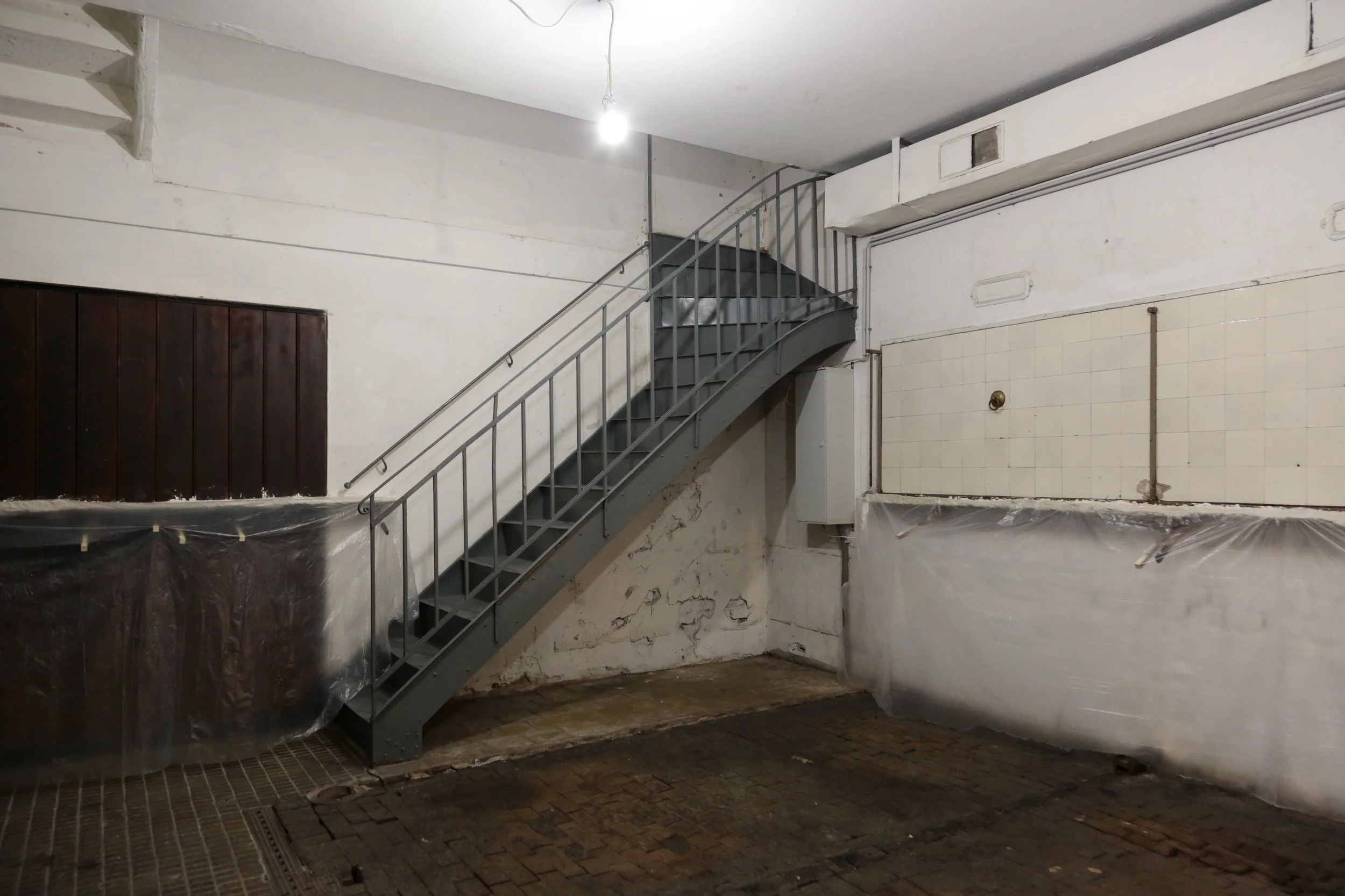   fig3  installation view, Ian Waelder,  accompaniment , 2025, paper mache, new and used piano keys, plastic film, air-dry porcelain, prints on paper, tape, switched-on light bulbs, site specific dimension 