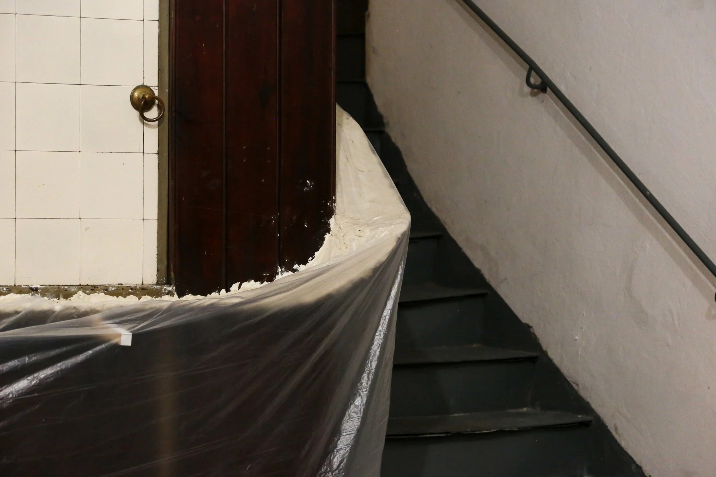   fig18  installation view, Ian Waelder,  accompaniment , 2025, paper mache, new and used piano keys, plastic film, air-dry porcelain, prints on paper, tape, switched-on light bulbs, site specific dimension 