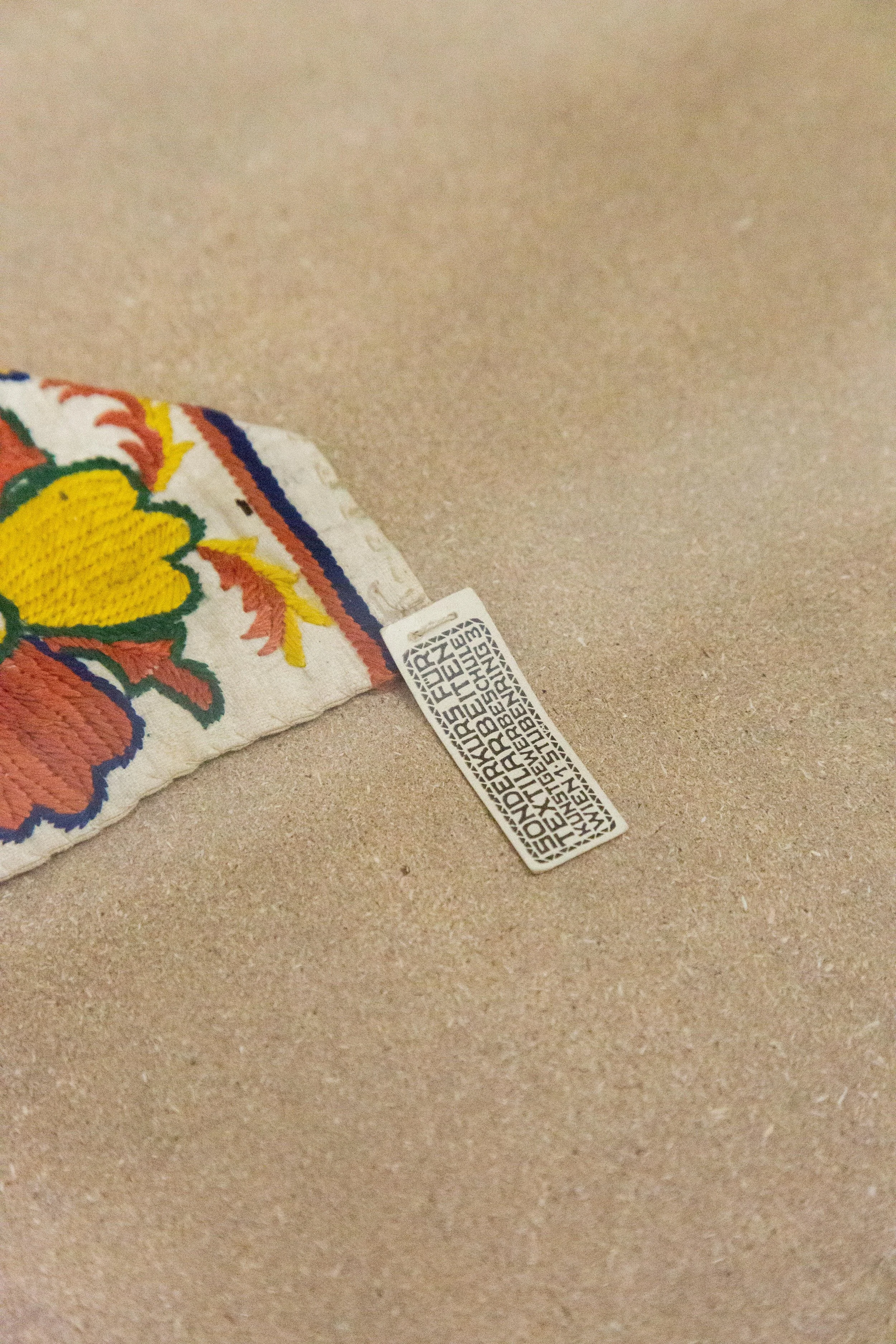   fig17  unknown artist, Schule / School Rosalia Rothansl,  Bodenhaube, Lehrmittel / Bonnet, teaching material,  1909 - 1911, Cotton, embroidered, 18 × 41 × 0,5 cm, On loan from the Collection and Archive, University of Applied Arts Vienna 