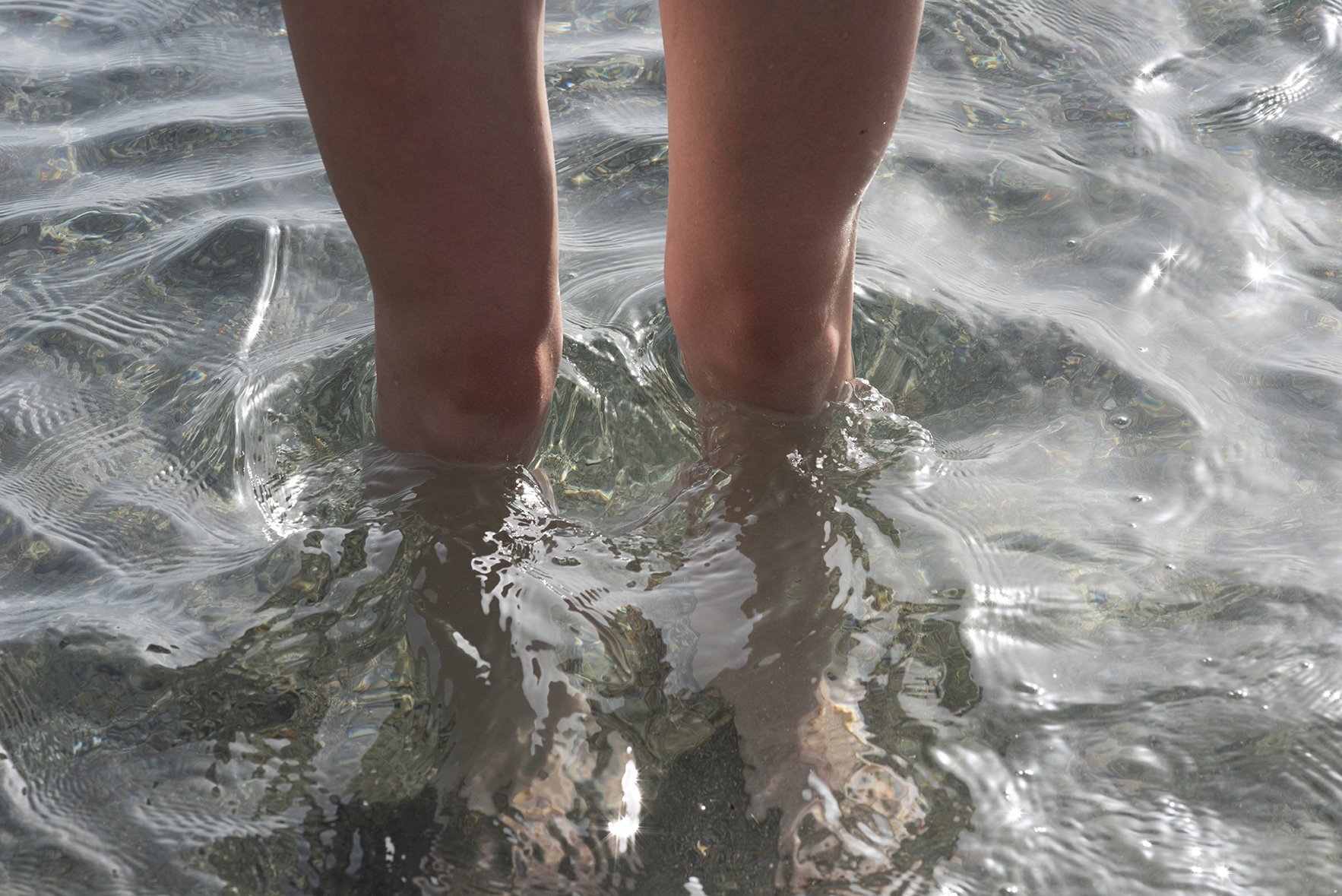  My legs changing the direction of the incoming sea at shore and feeling the power of the water. 
