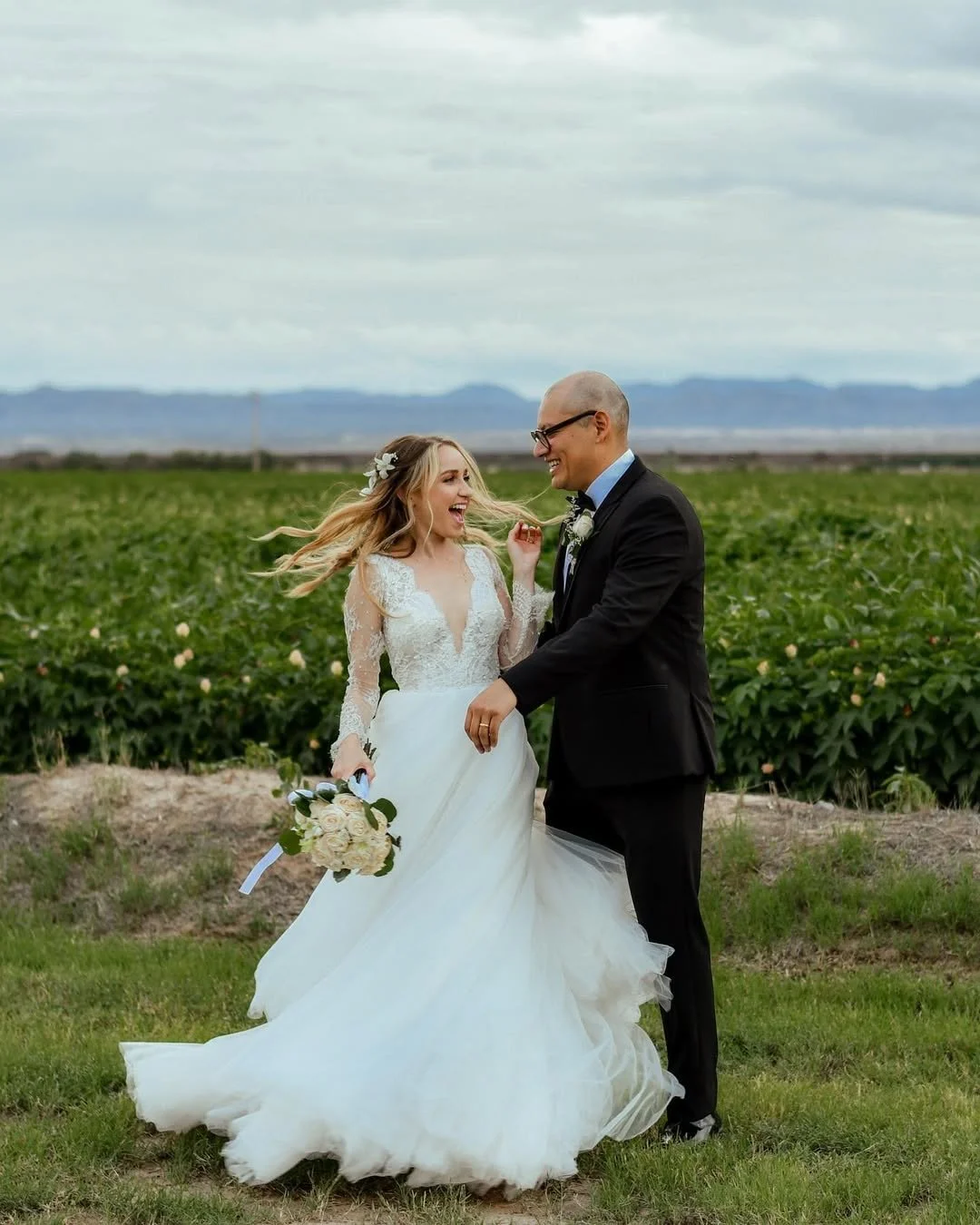 A happy couple celebrating their wedding day at the meadows in El Paso Fabens texas surrounded by cotton fields