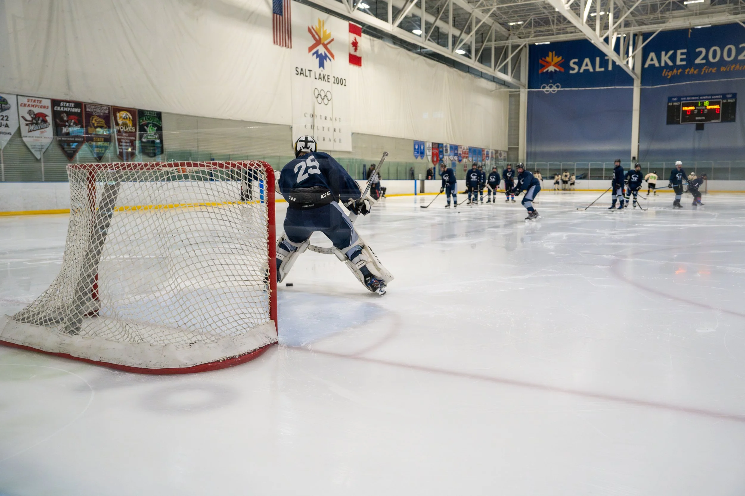 Hockey players practicing on an ice rink during a team practice or game.