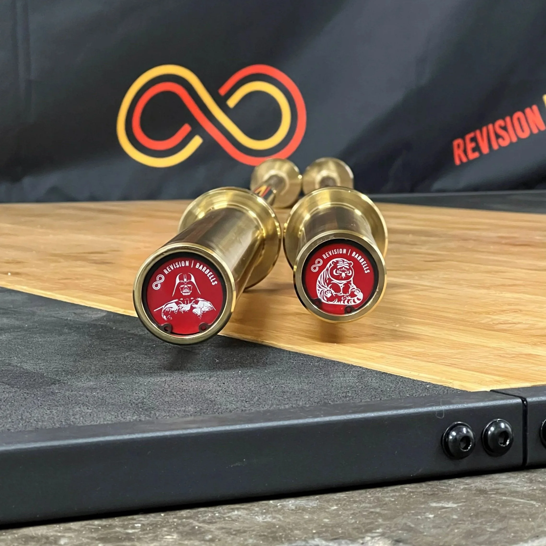 Revision Custom Red Barbell End Caps on Gold Revision Barbell