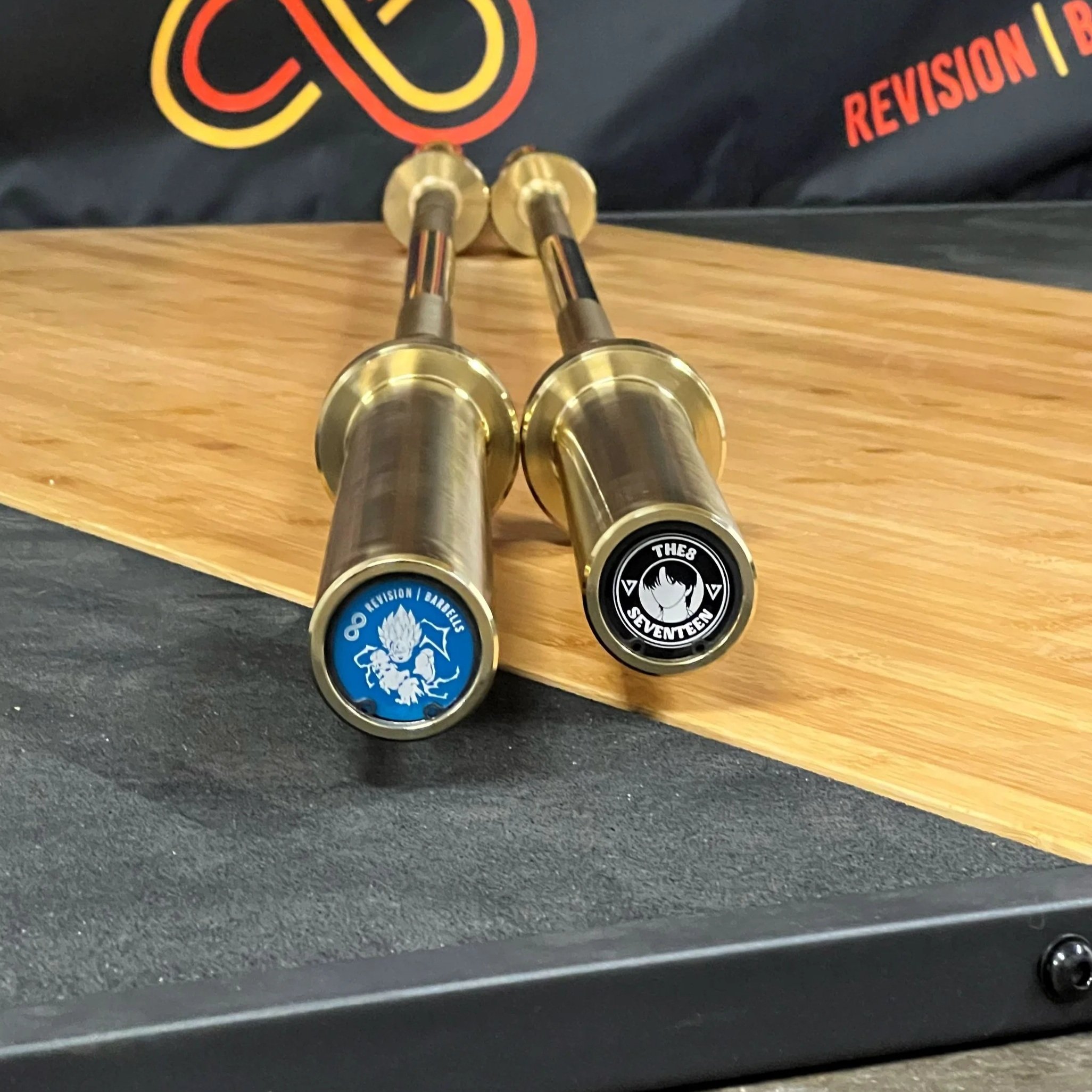 Revision Custom Light Blue and Black Barbell End Caps on Gold Revision Barbell