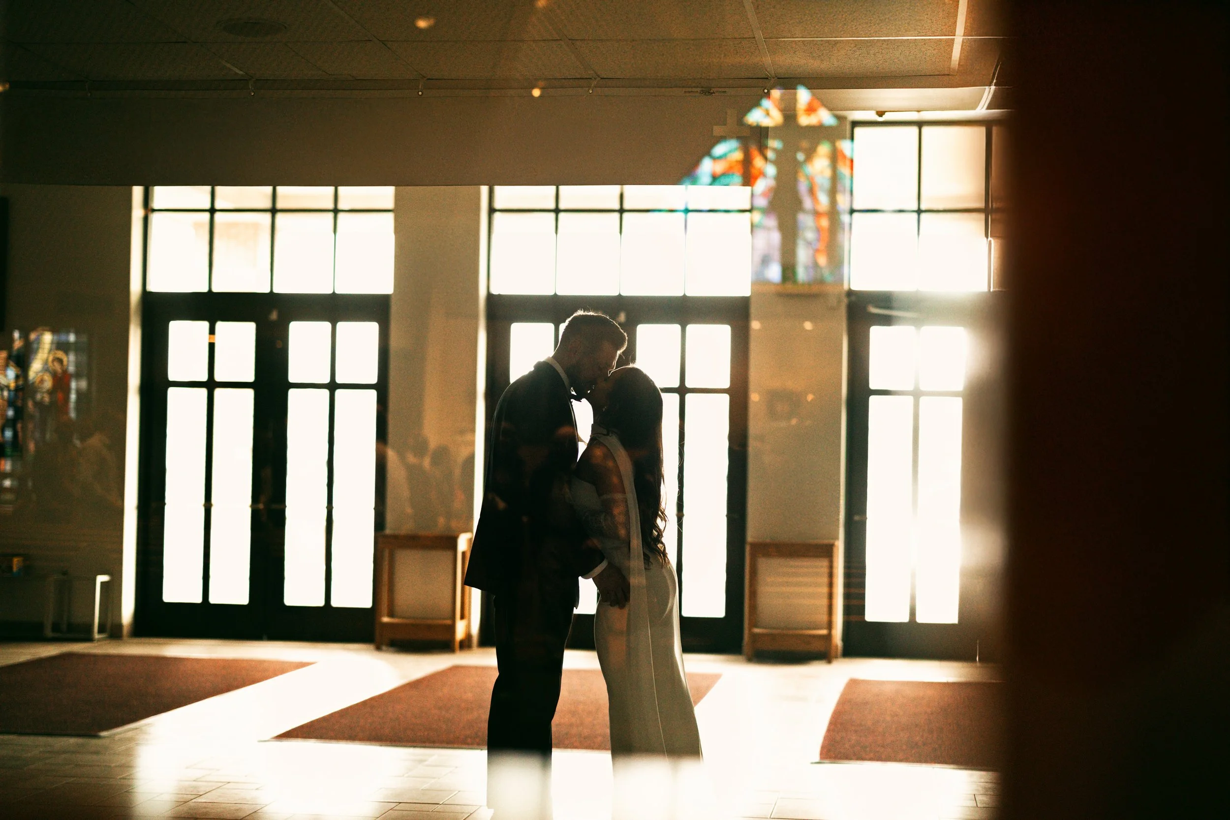 Newlyweds sharing a joyful moment outside St. Ignatius Church in Sinking Spring, Pennsylvania, after a traditional Berks County wedding ceremony.