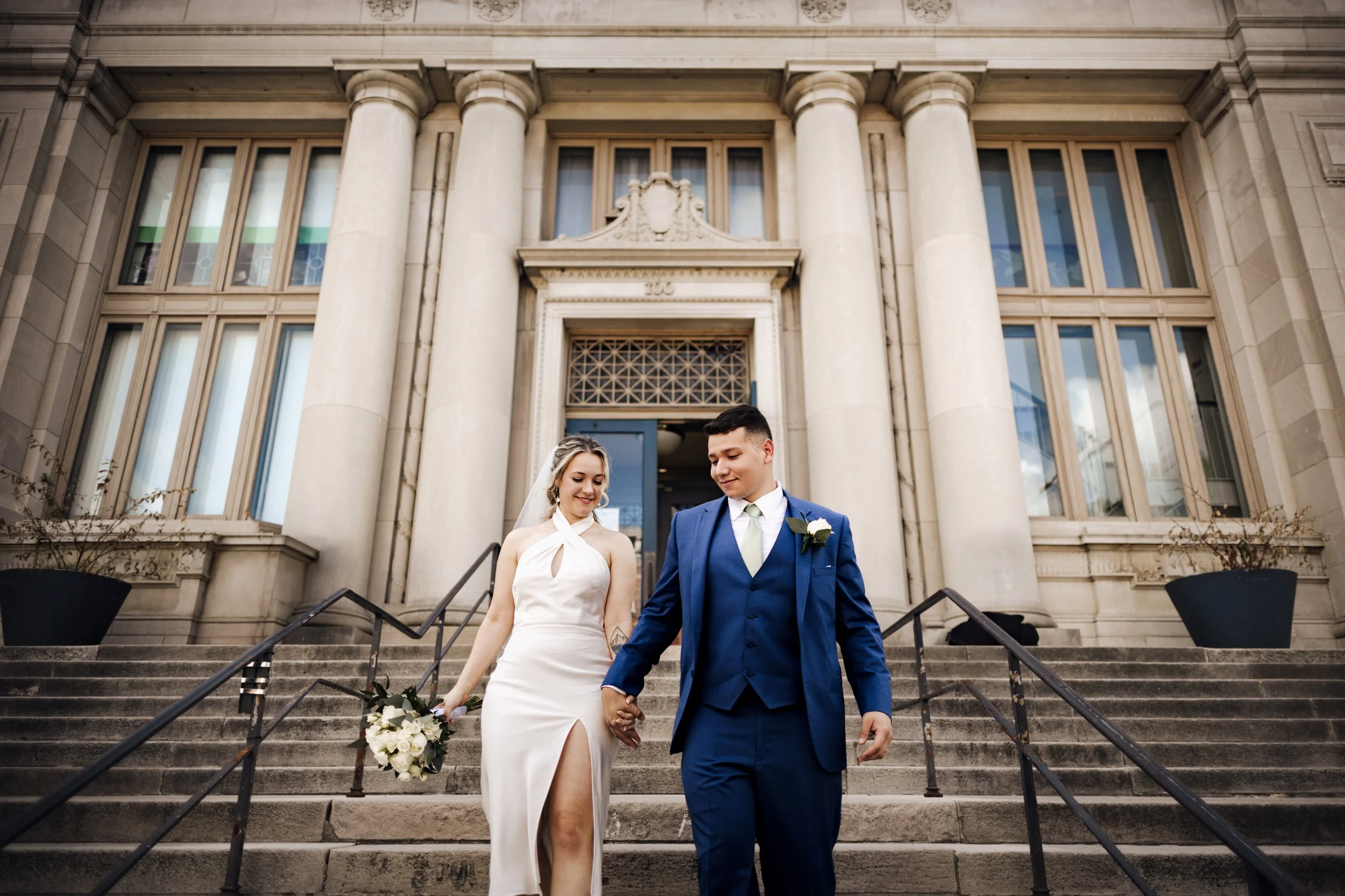 Newlyweds walking through downtown Reading, PA, after their intimate micro wedding, captured by a local wedding photographer.