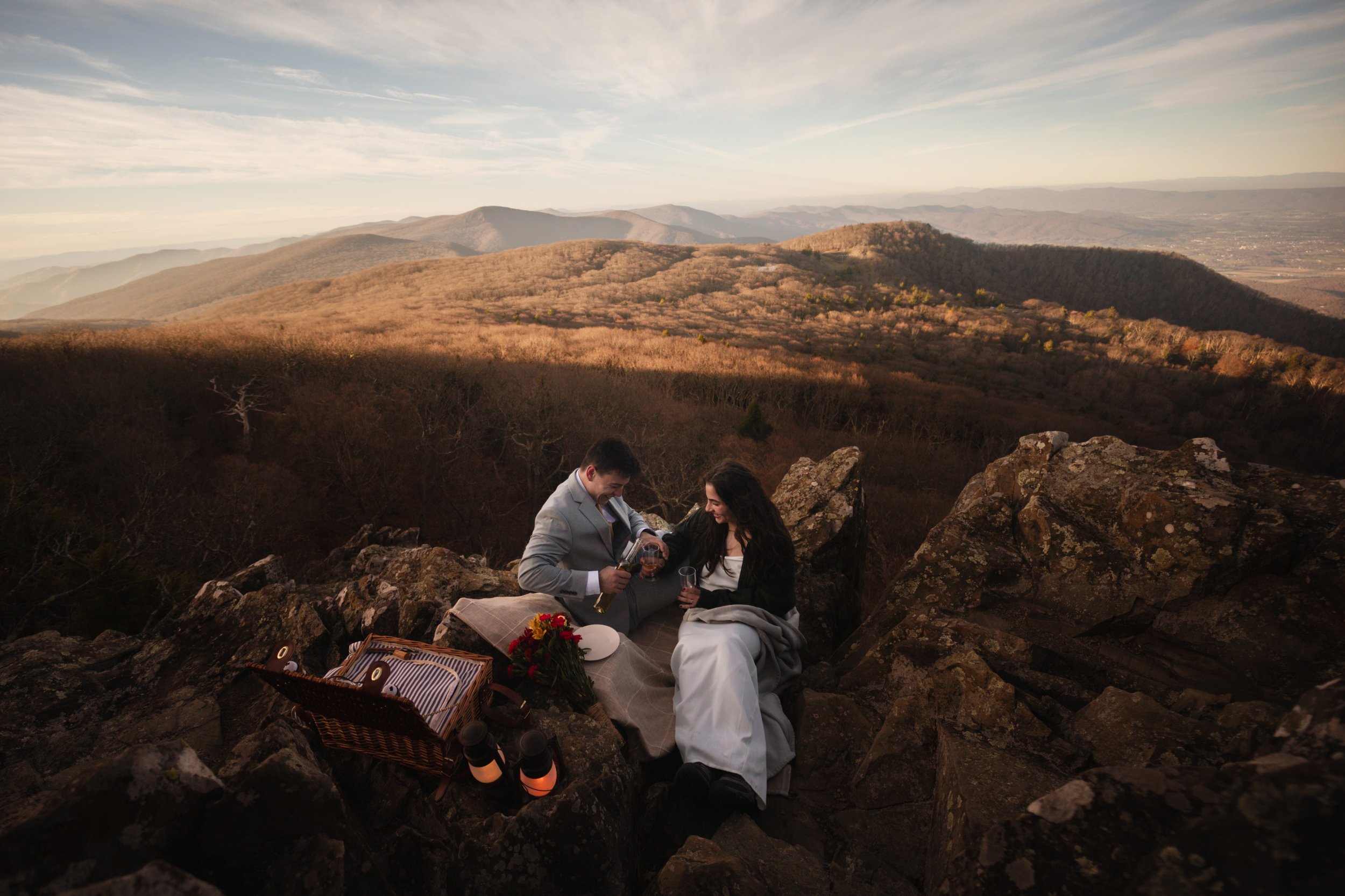 Breathtaking Blue Ridge Mountain elopement in Pennsylvania with a couple standing on a rocky overlook during golden hour in the Appalachian range