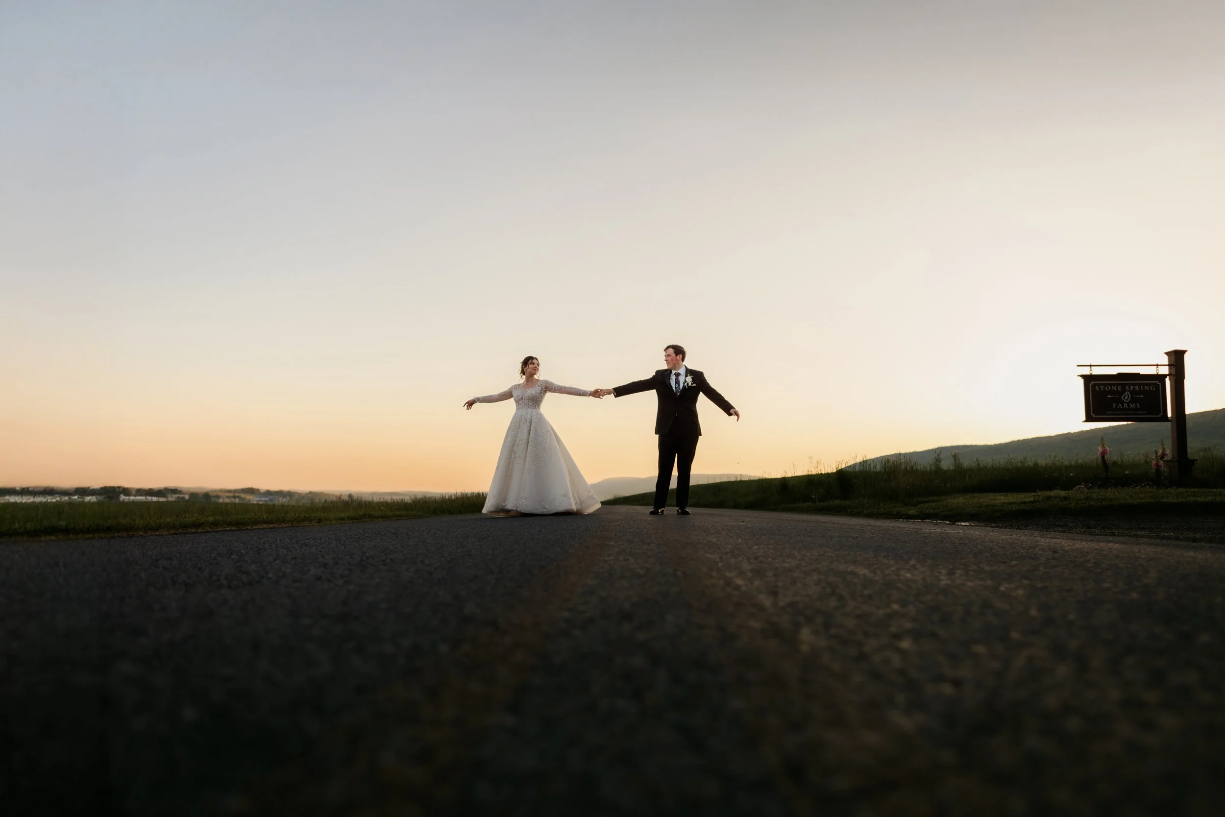 Romantic and intimate sunset wedding portrait featuring a close-up moment between a bride and groom. Creative golden hour photography at Stone Spring Farms, an elegant Berks County wedding venue.
