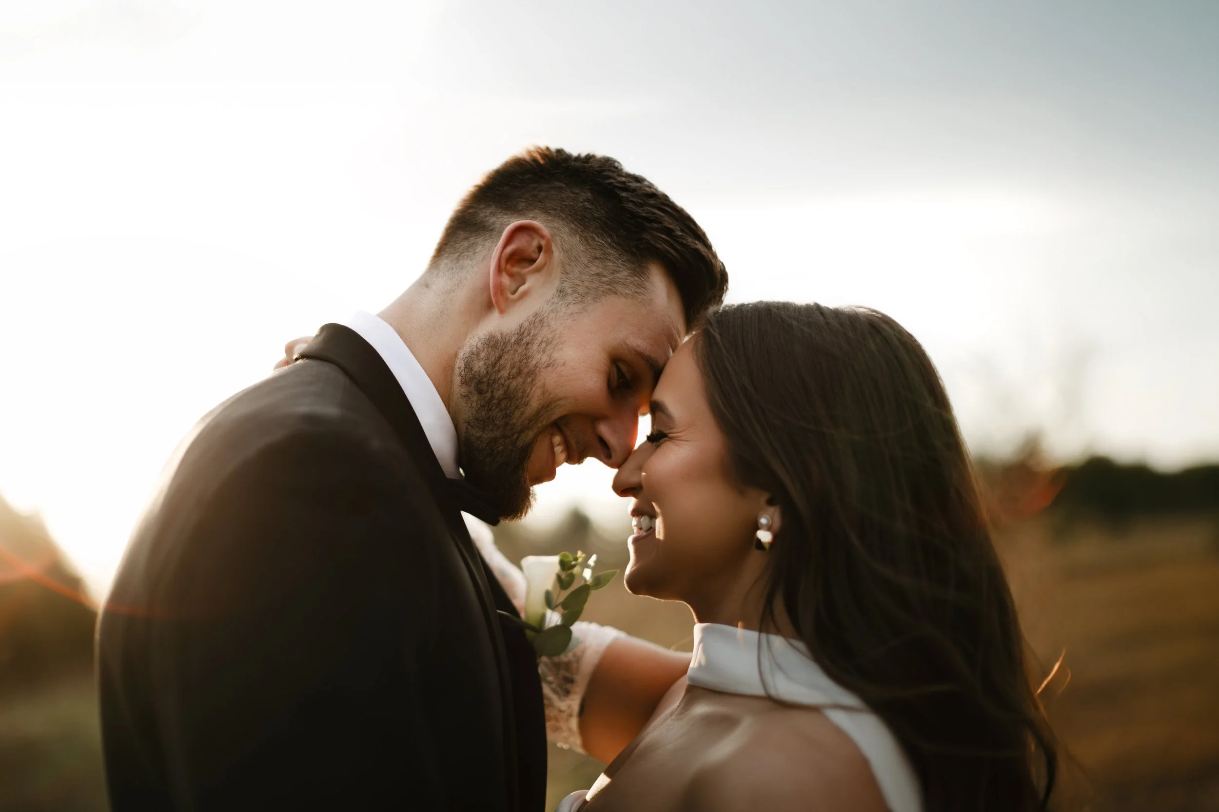 Close-up of a wedding couple embracing during a sunset session in Wyomissing Park, capturing authentic emotion and fine-art wedding photography details in Berks County.