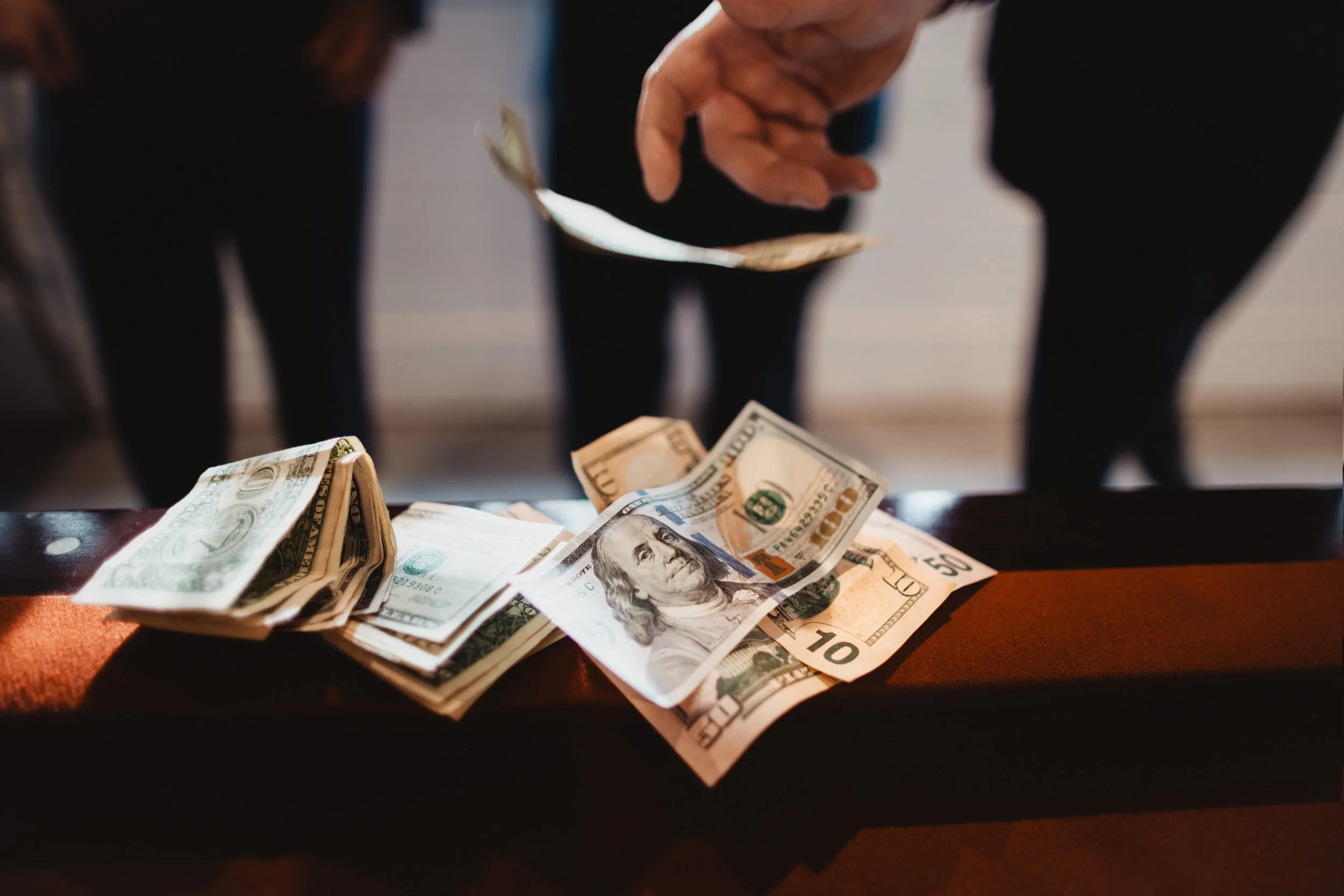 Close up of cash on a pool table during a relaxed, non-traditional micro wedding celebration in Central Pennsylvania.