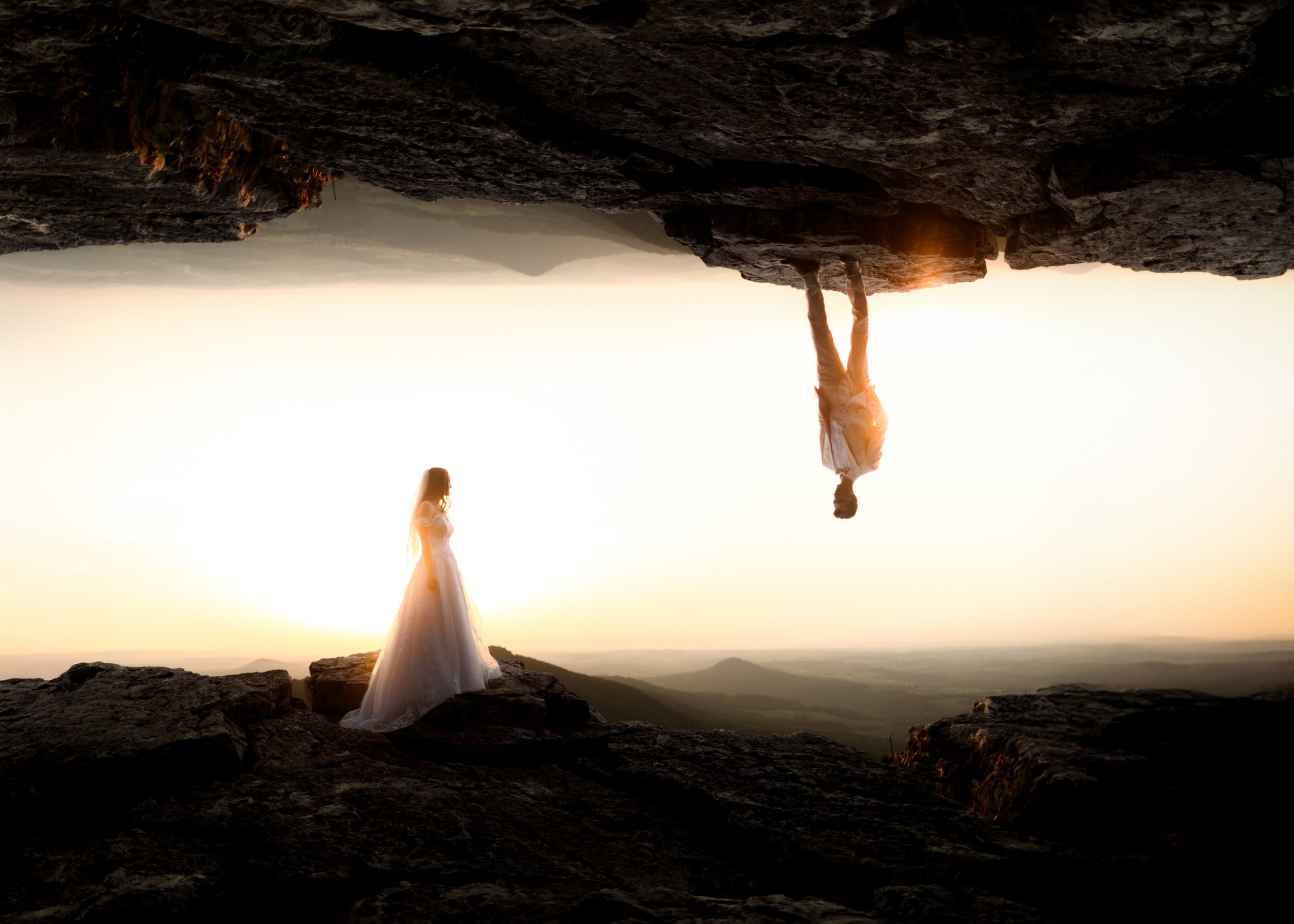 ouble exposure artistic photo combining a silhouette of an eloping couple with a foggy sunrise mountain landscape in Berks County PA