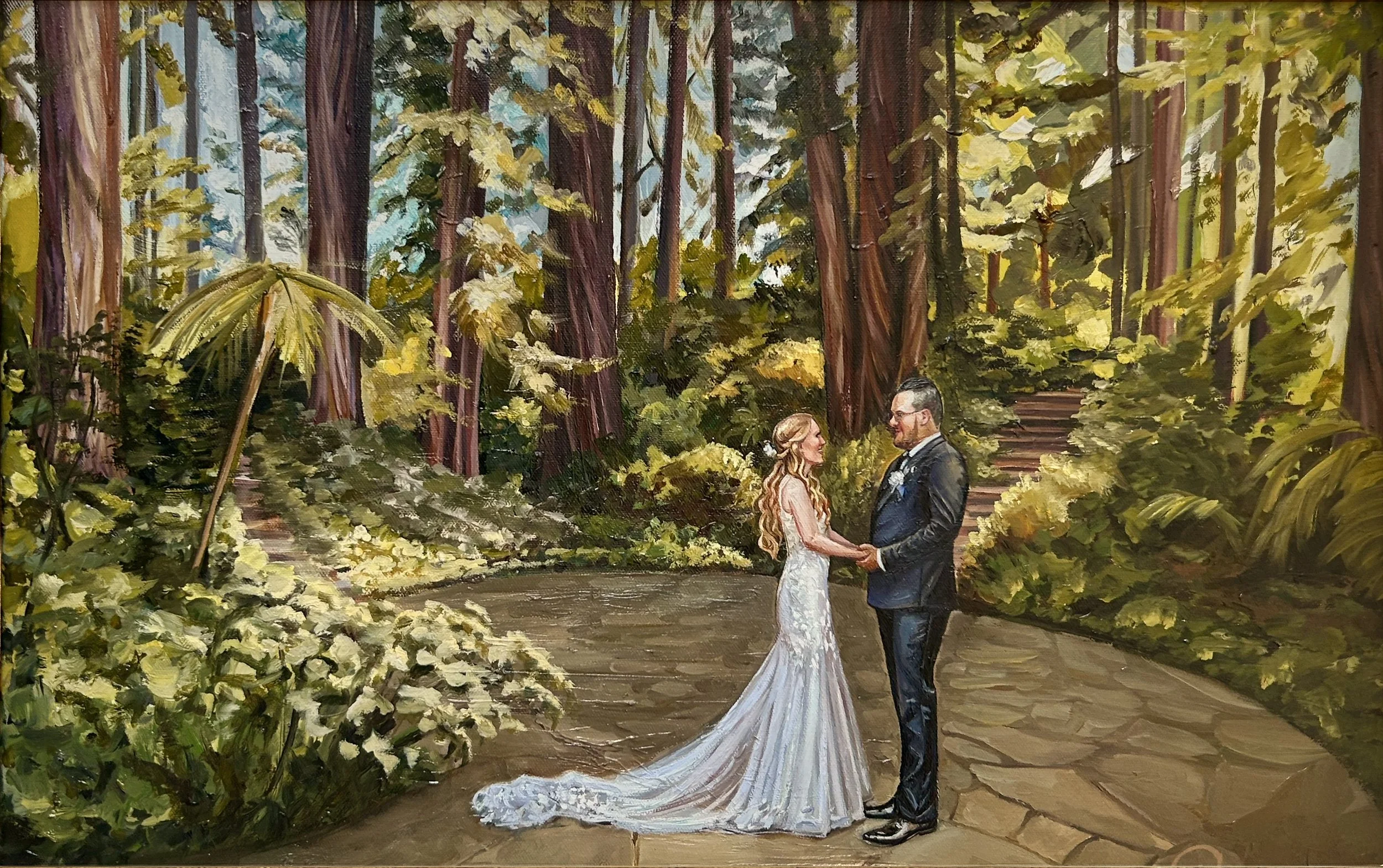 A bride and groom holding hands and facing each other on a stone pathway in a lush forest with tall trees and greenery, sunlight filtering through the leaves.