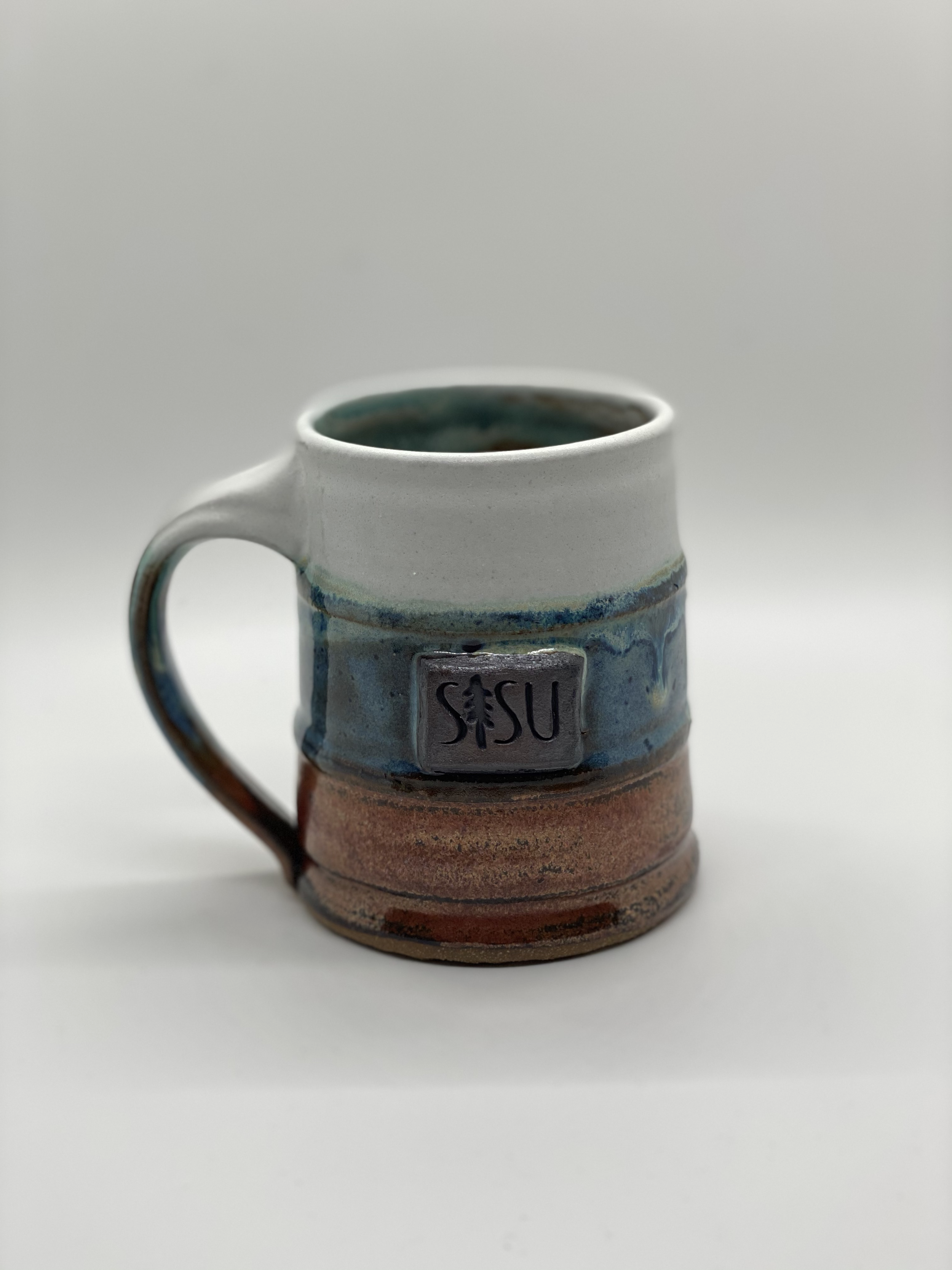 SISU Ecological School Custom Barrel mug with iron stain logo medallion.