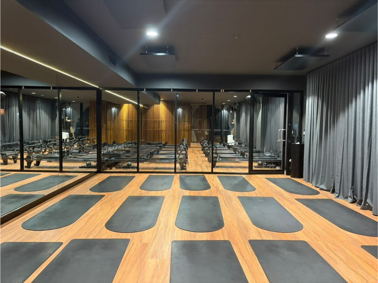 Inside You Wellness Club Palmyra: the infrared hot Pilates studio with the reformer studio behind the glass