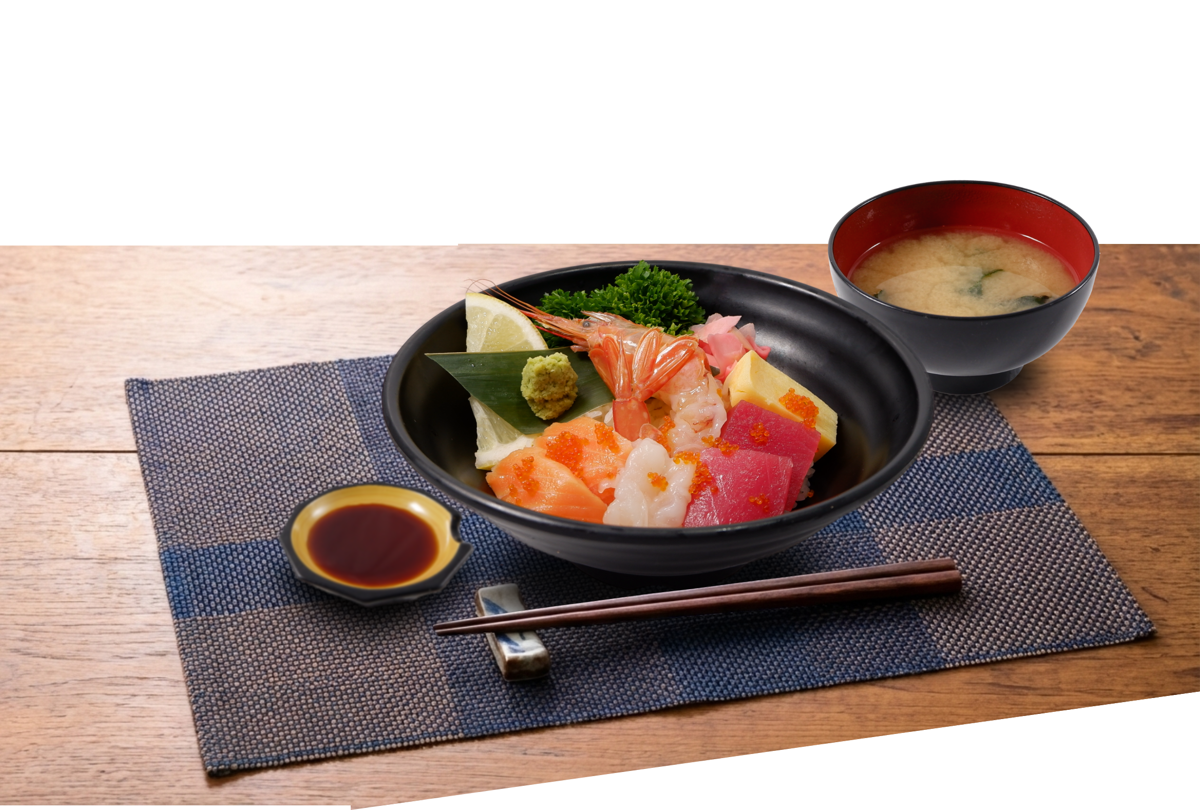 Assorted sashimi donburi topped with tuna, salmon and prawns, served with miso soup