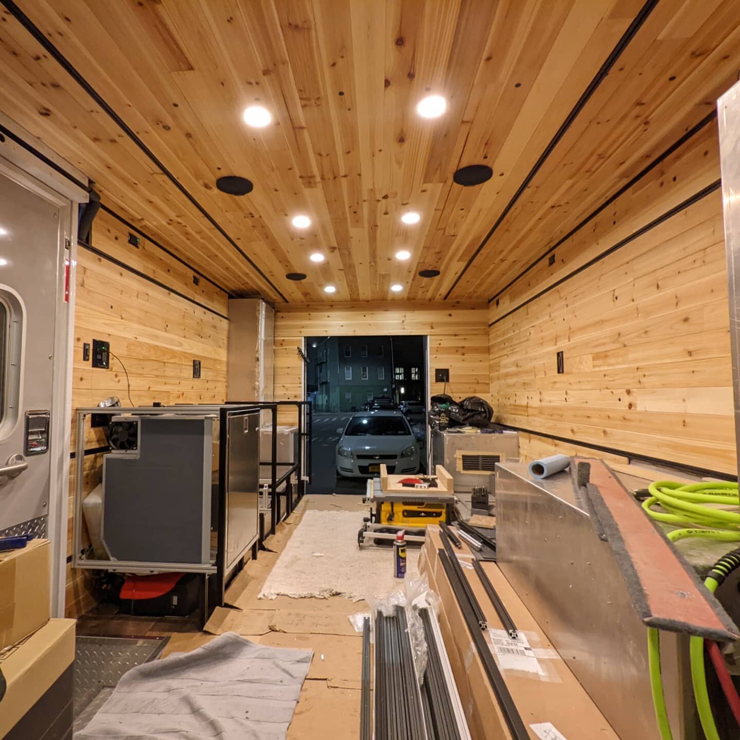 Ambu conversion base layer is done:

1/4&quot; cedar all around, attached to recessed plywood ribs in the ceiling, and attached to solid 1/4&quot; plywood on the walls. The wall panels are easy to unbolt to get behind, the ceiling panels are also the