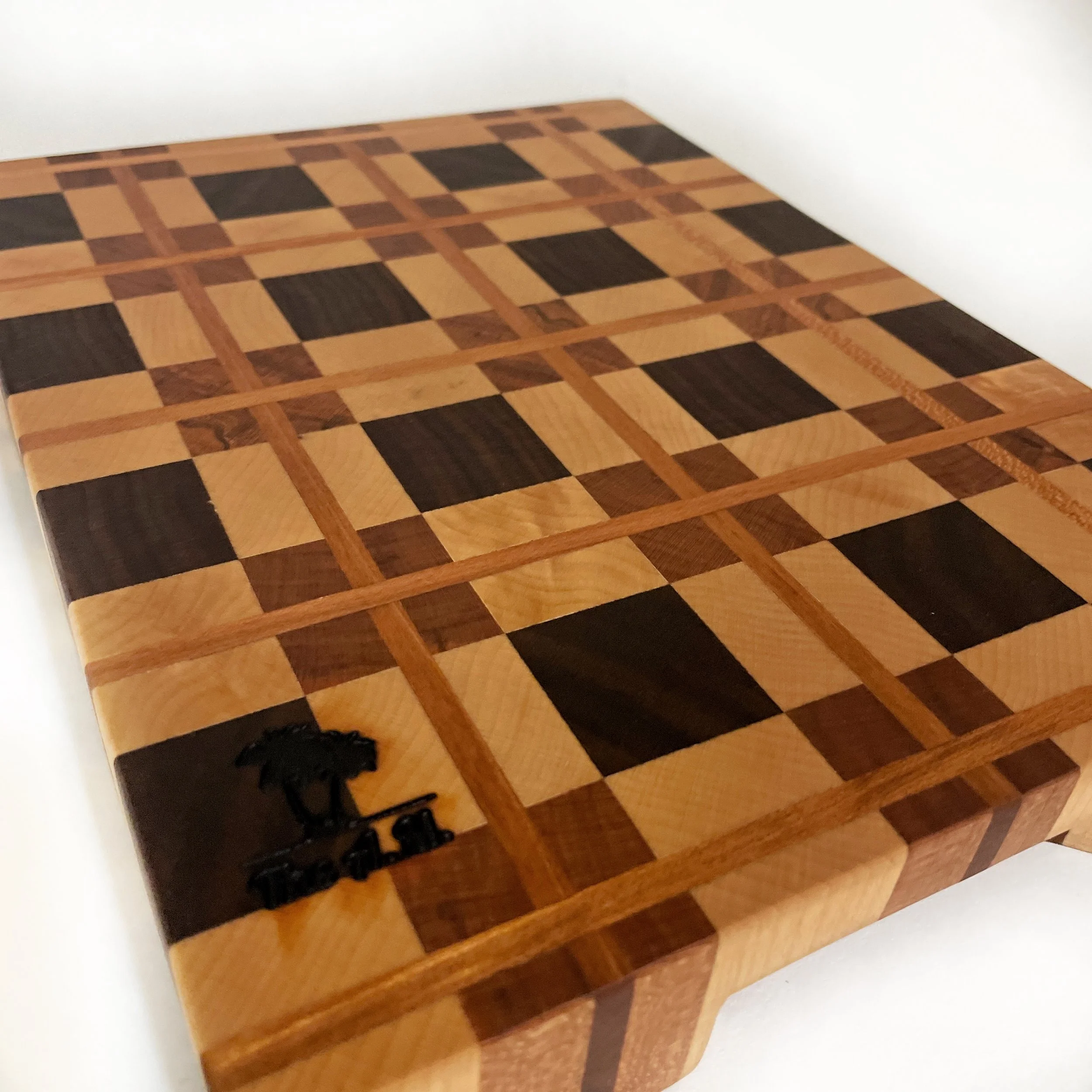 Close-up detail of Arden Noble edge grain surface showcasing plaid layout and natural wood tones