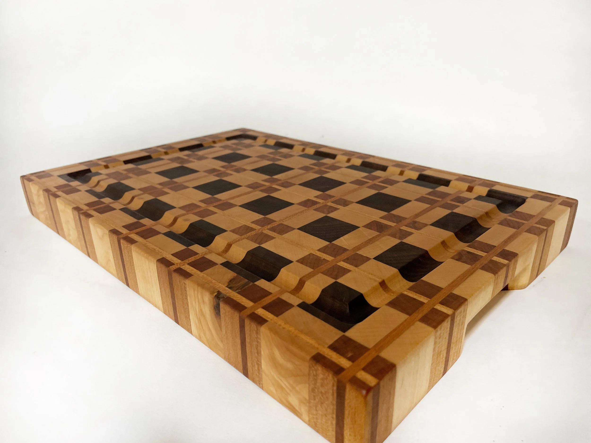 Arden Grand large handcrafted cutting board with plaid pattern in maple cherry and walnut