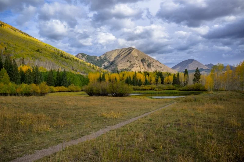 
Warner Lake — Beneath the La Sal Peaks / 
Moab, Utah / 
DSC0876 /
Mount Mellenthin rises above Warner Lake in the heart of the La Sals, with Mount Tukuhnikivatz also prominent in this area.  Autumn aspens frame the quiet meadow as gathering clouds b