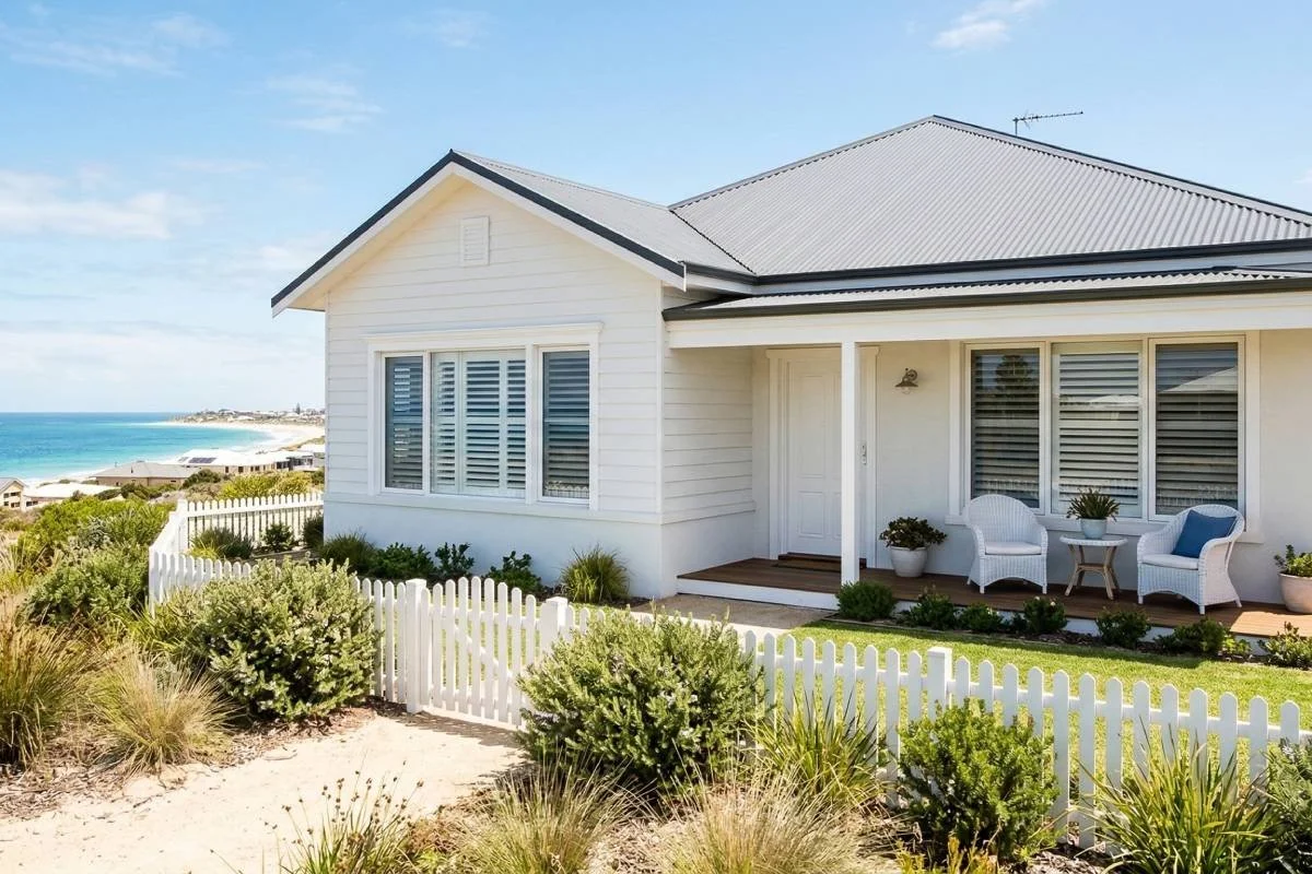 Coastal Perth home exterior featuring white Hampton style window shutters under a sunny blue sky