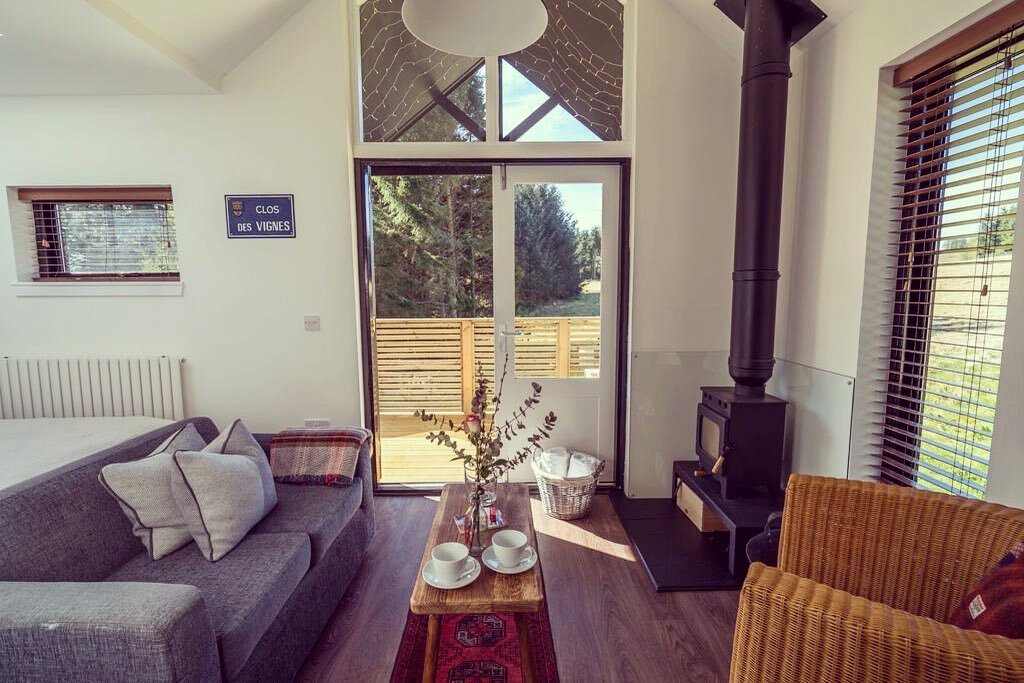 The Cabin is open plan and features a double bed with overhead light well for stargazing. A comfortable seating area leads out to decking where you can enjoy looking out across the unspoilt woodland view. Look out for Red Squirrels! 
&bull; Image of 
