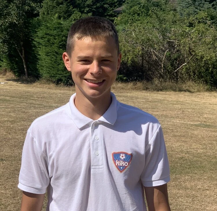 Silhouette of a person with short hair seen from the front.