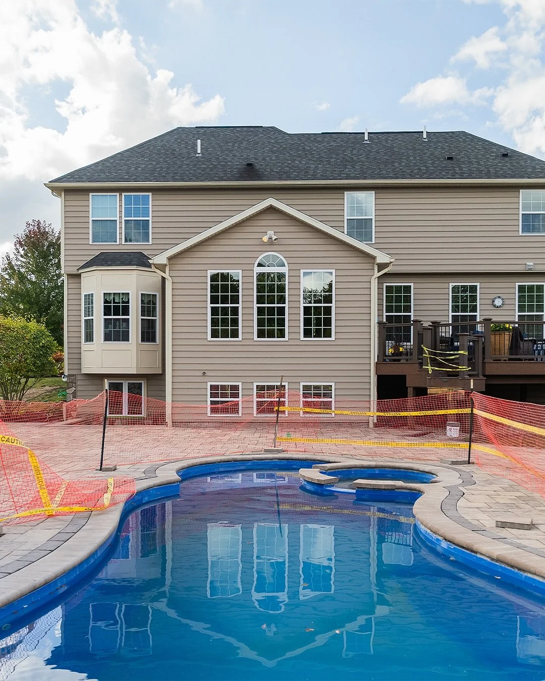 Backyard goals in Pittsford, NY! This space features a fiberglass pool + spa, custom paver patio, and a covered structure with a fireplace, bar, TV, and plenty of room to hang out. The ultimate staycation spot!