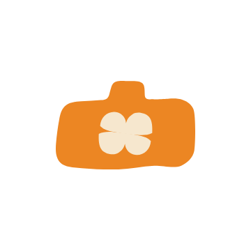 Orange camera with a beige flower in the lens