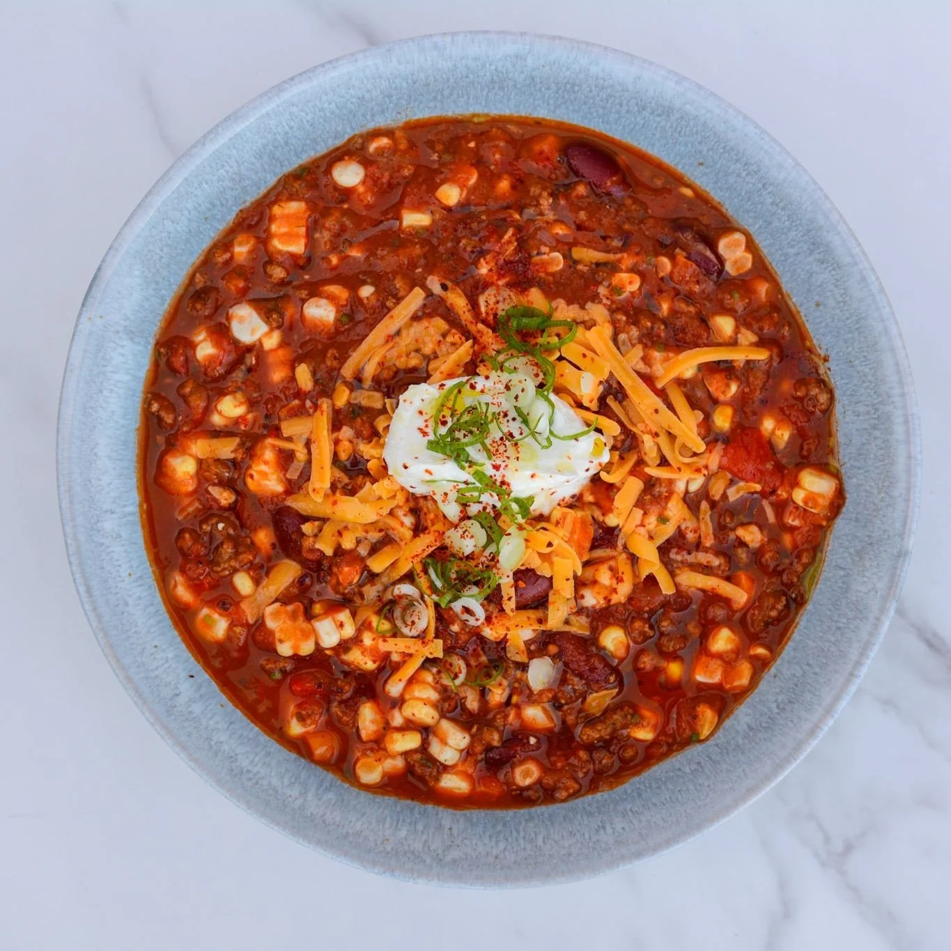 Happy October 1st! 🎃⁠
⁠
A classic chili loaded with ground beef, market vegetables, beans, a hint of spice &amp; fresh herbs. Top it with shredded cheese &amp; a dollop of whipped cream. A hearty meal that is always a crowd pleaser! ⁠
⁠
Place your o