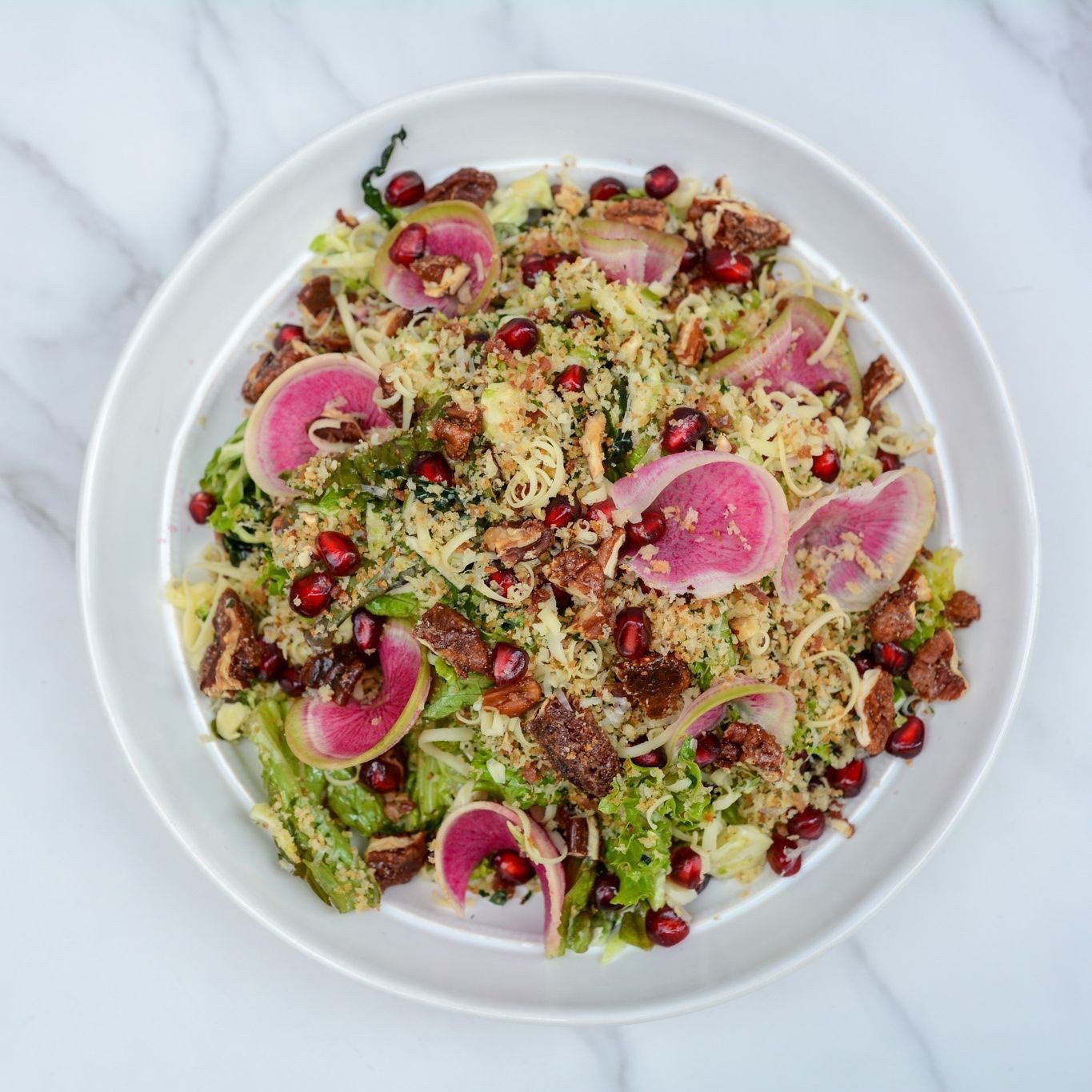 A delightful crunch in every bite, packed with fresh flavour!⁠
⁠
This delicious winter salad is loaded with shaved Brussels sprouts, smoked gouda, candied pecans &amp; pickled red onion. Topped with our house made maple vinaigrette for an added sweet