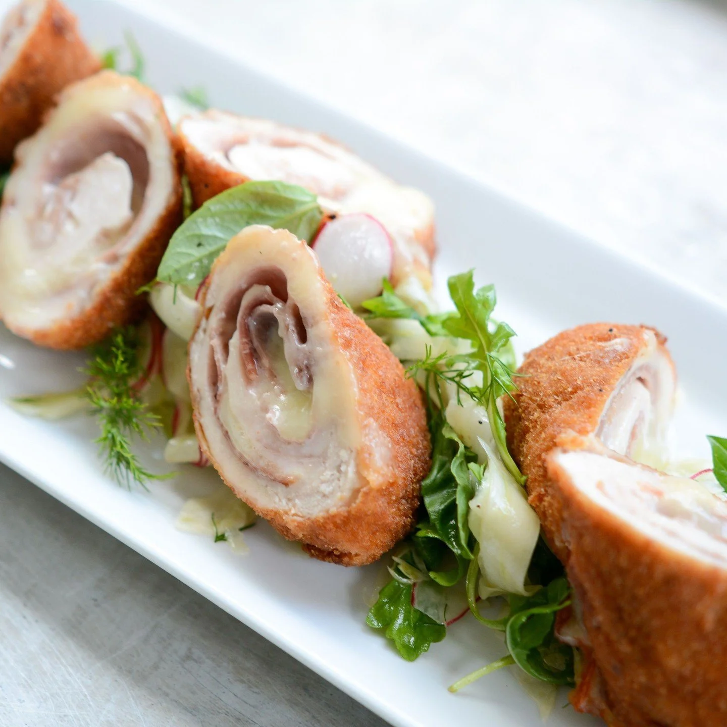 Comfort feature of the week! 😋⁠
⁠
Bolognese Style Chicken Roulade with Fennel Radish Slaw⁠
⁠
Chicken cutlets stuffed with prosciutto &amp; cheese rolled up, breaded &amp; fried to perfection. Served with a zesty fennel radish slaw for an extra pop o