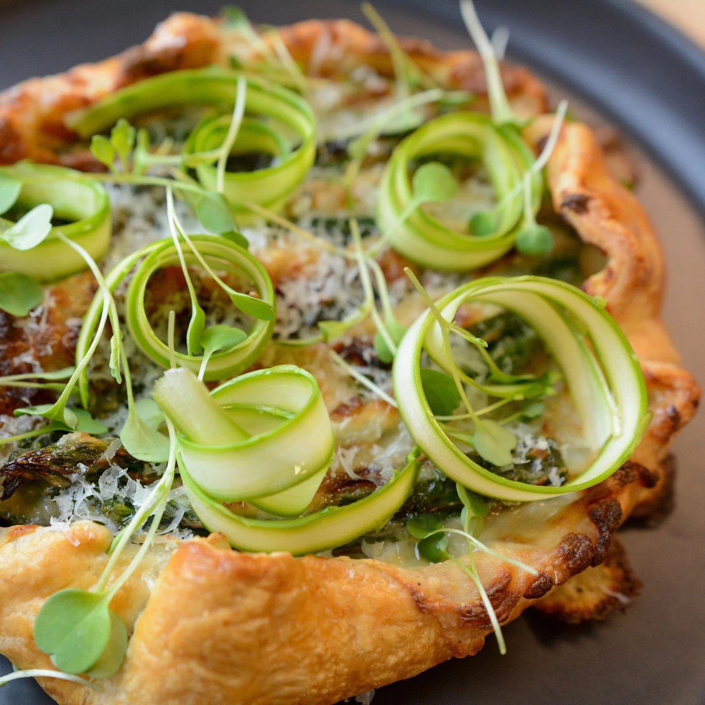 Celebrate local asparagus season with this week's feature Asparagus Tart.⁠
⁠
Made with locally grown asparagus @barries_asparagus , flaky buttery pastry, fontina cheese, and house-made bacon onion jam. It is the perfect balance of savoury, rich, and 