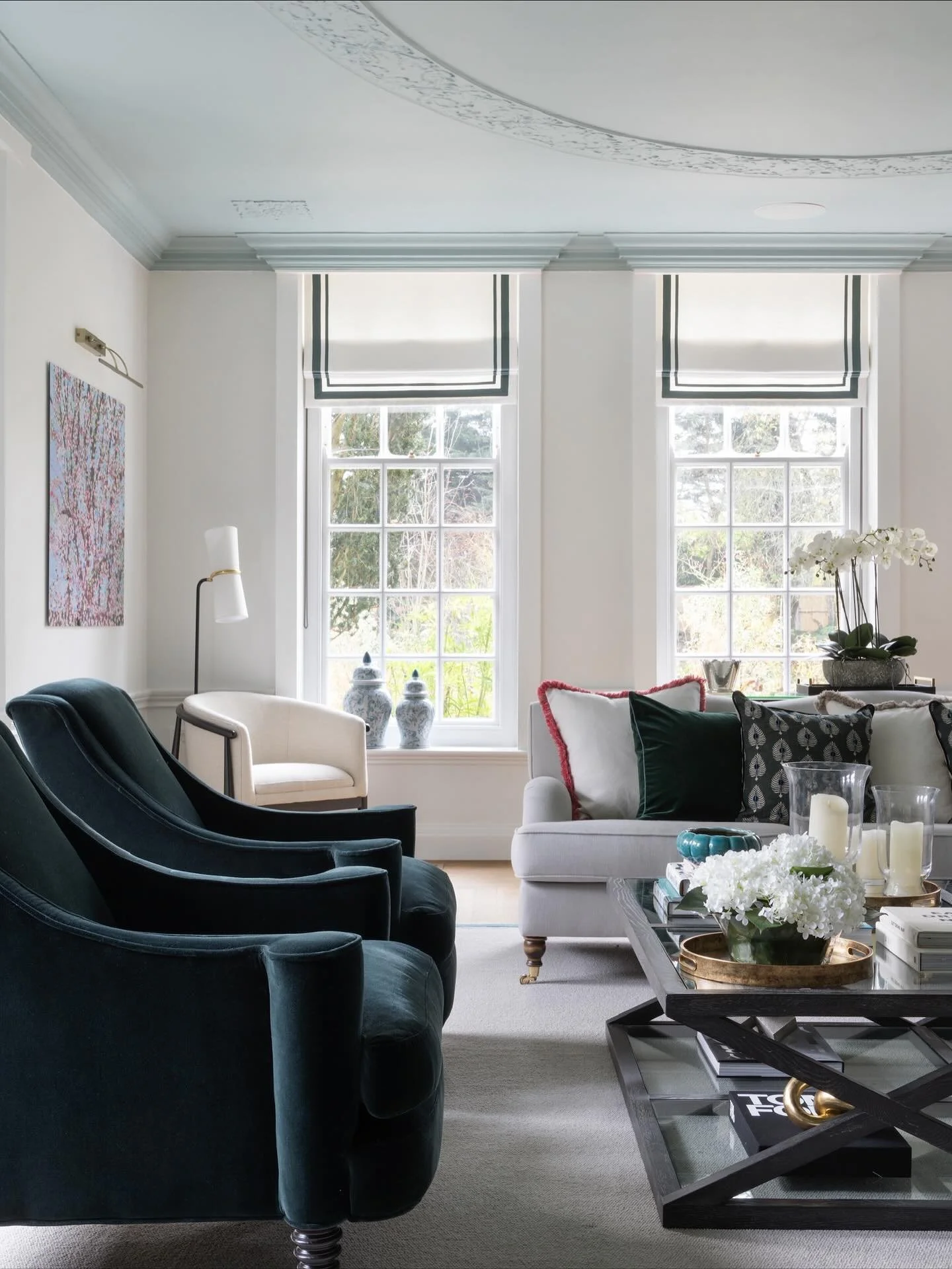 This room previously had all its beautiful architectural details hidden. So we got rid of the overbearing curtains and replaced them with smart blinds. And we drew attention to the stunning ceiling by painting it a lovely sea glass colour. 
 
Swipe t