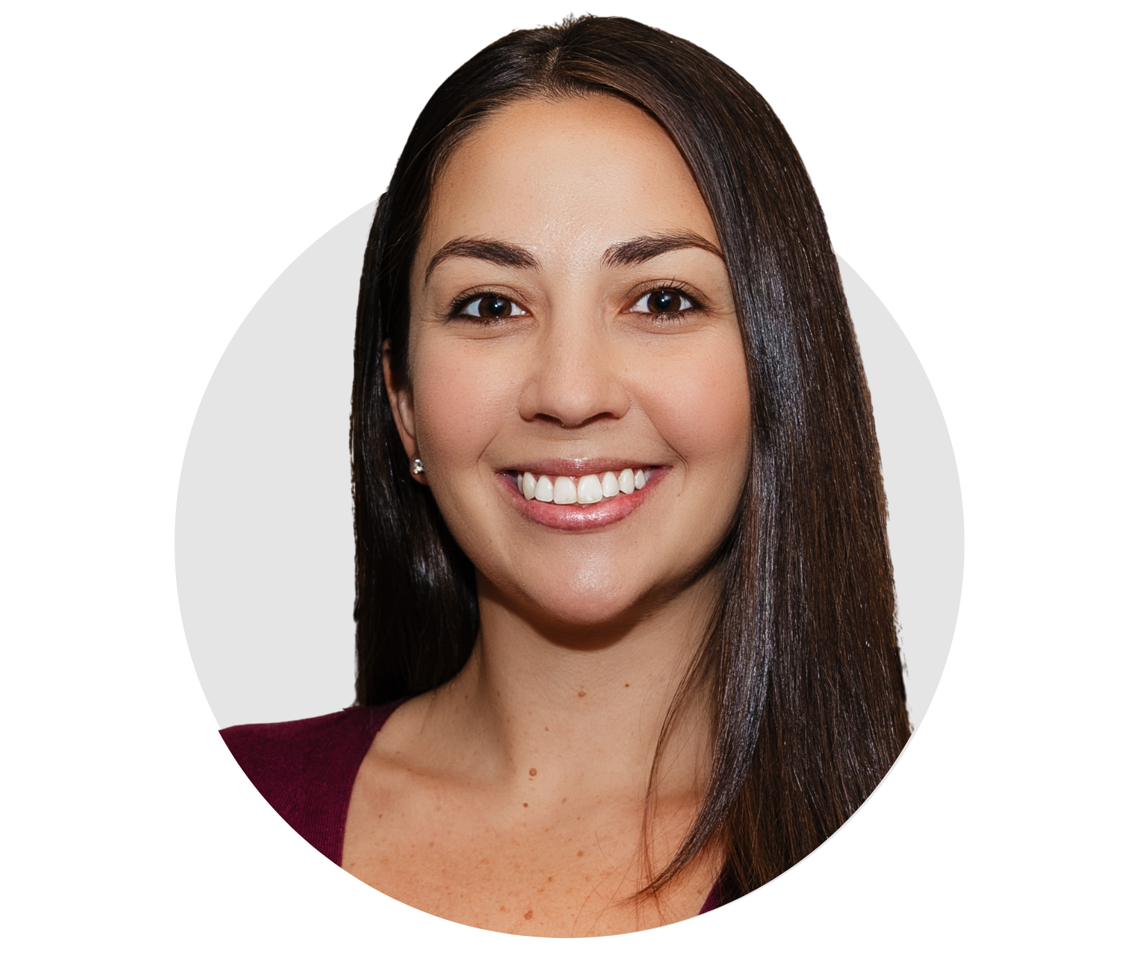 Headshot of a smiling woman with long, straight brown hair, wearing a maroon top, and pearl earrings.