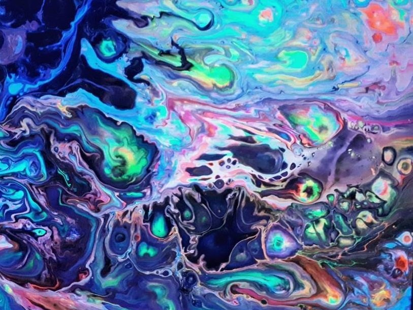 Abstract swirling mixture of vibrant colors including blue, green, pink, purple, and orange.