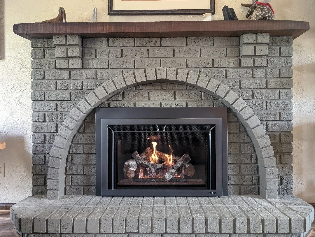 gas fireplace insert with gray brick surround