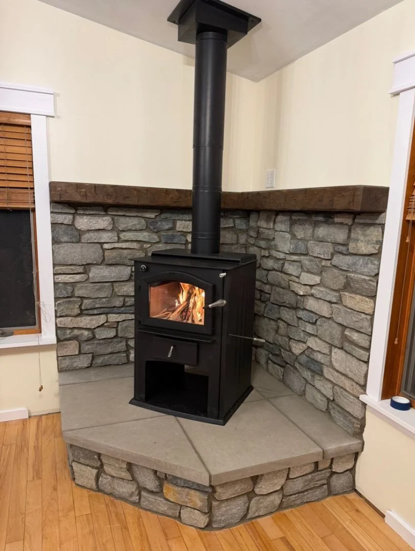 ignited kuma aberdeen stove on a stone platform