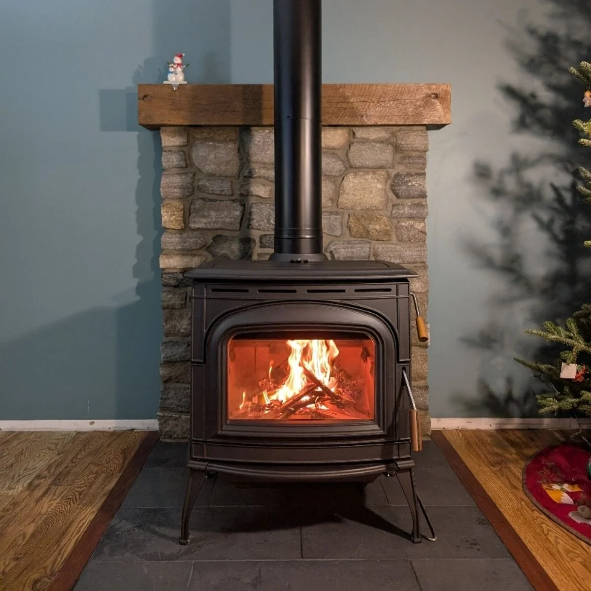 grey standing wood stove with flames