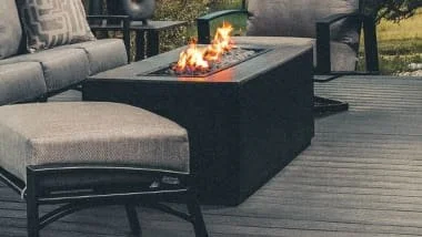 long black outdoor fireplace with gray furniture