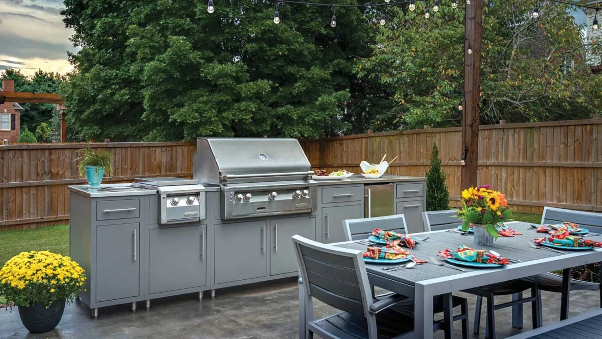 outdoor kitchen with gray finish in a backyard