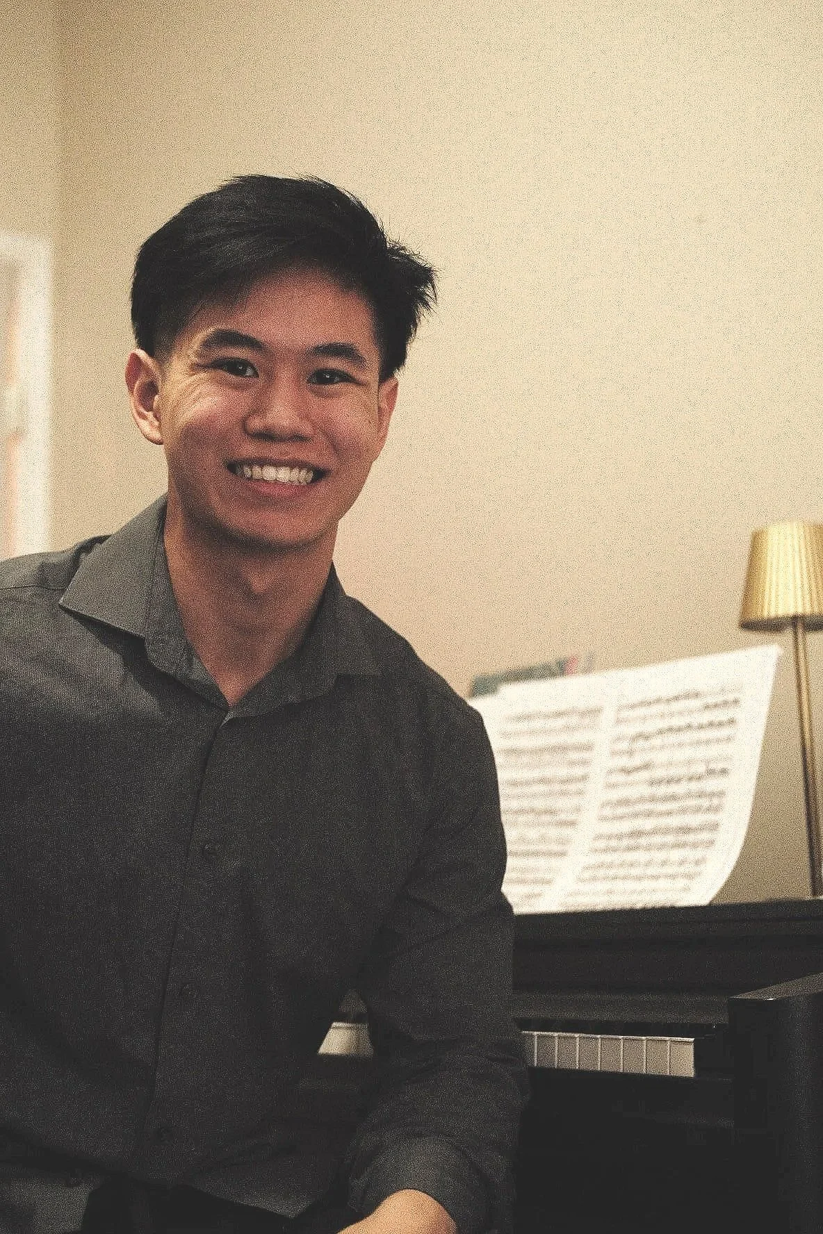 Smiling Kevin with his piano. He is one of the piano teacher in Saskatchewan