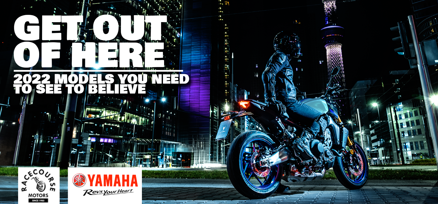 Night city scene with a person in motorcycle gear riding a Yamaha motorcycle on a city street, illuminated by colorful building lights, with urban skyscrapers and the Tokyo Skytree in the background; promotional text for model models in 2022.