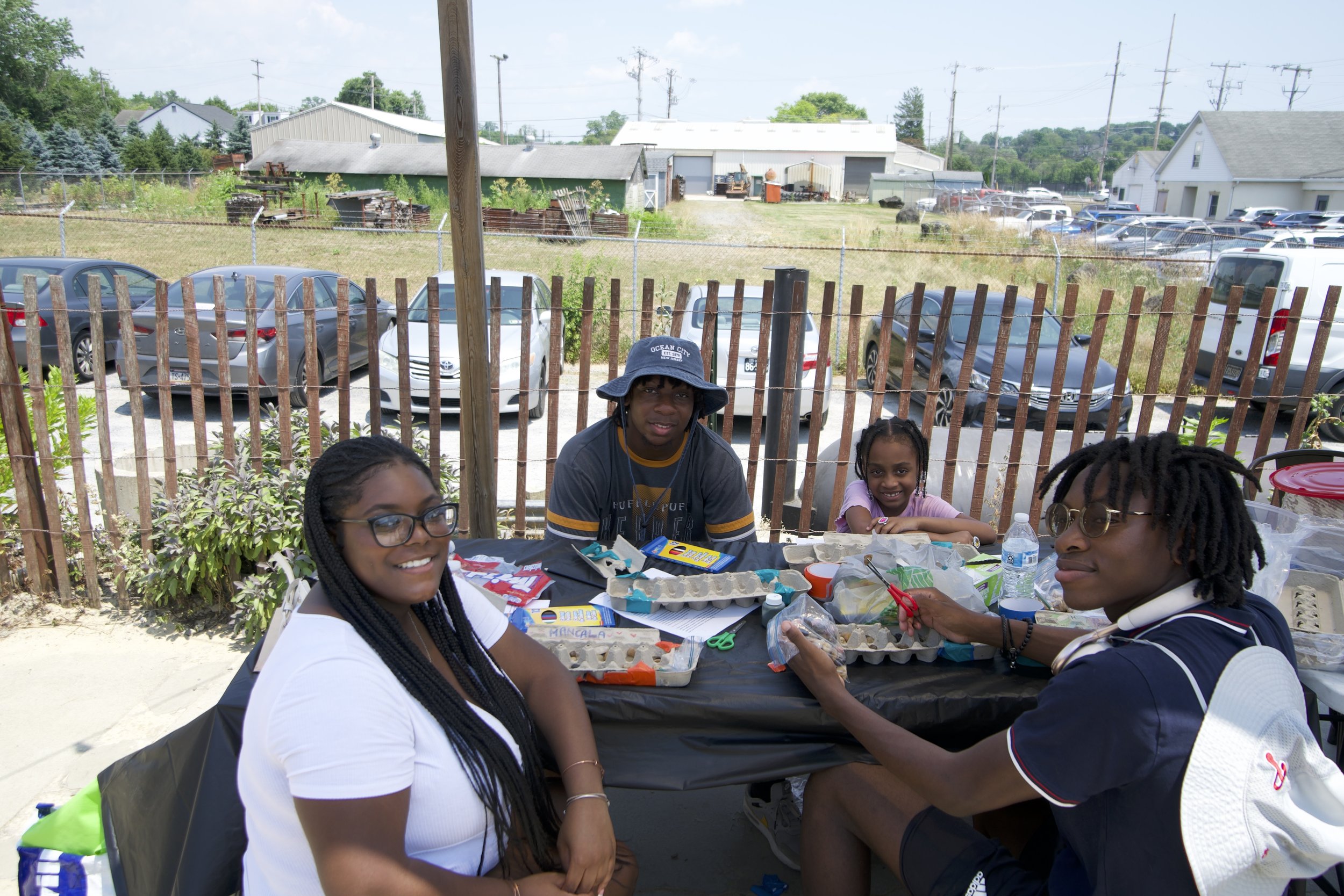 Group of young adults and kids enjoying crafts at Kennett Creamery's Juneteenth festival 2024. 