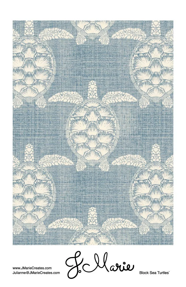 A patterned rug featuring blue background with white sea turtles design and a signature by J. Marie.