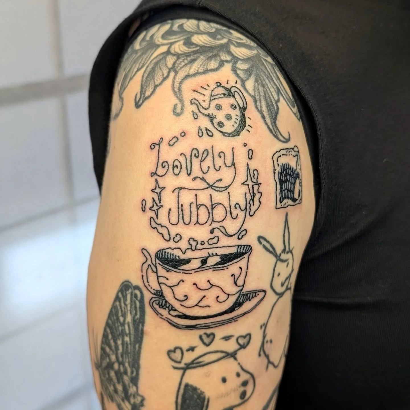 A cuppa tea tattoo made while drinking a cuppa ☕ 
we combined some of my flash and tiles to fill in some gaps today and it fits lovely. We did a lot of other bits today too including a honey pot tile next to a bear cover up that I worked on last year