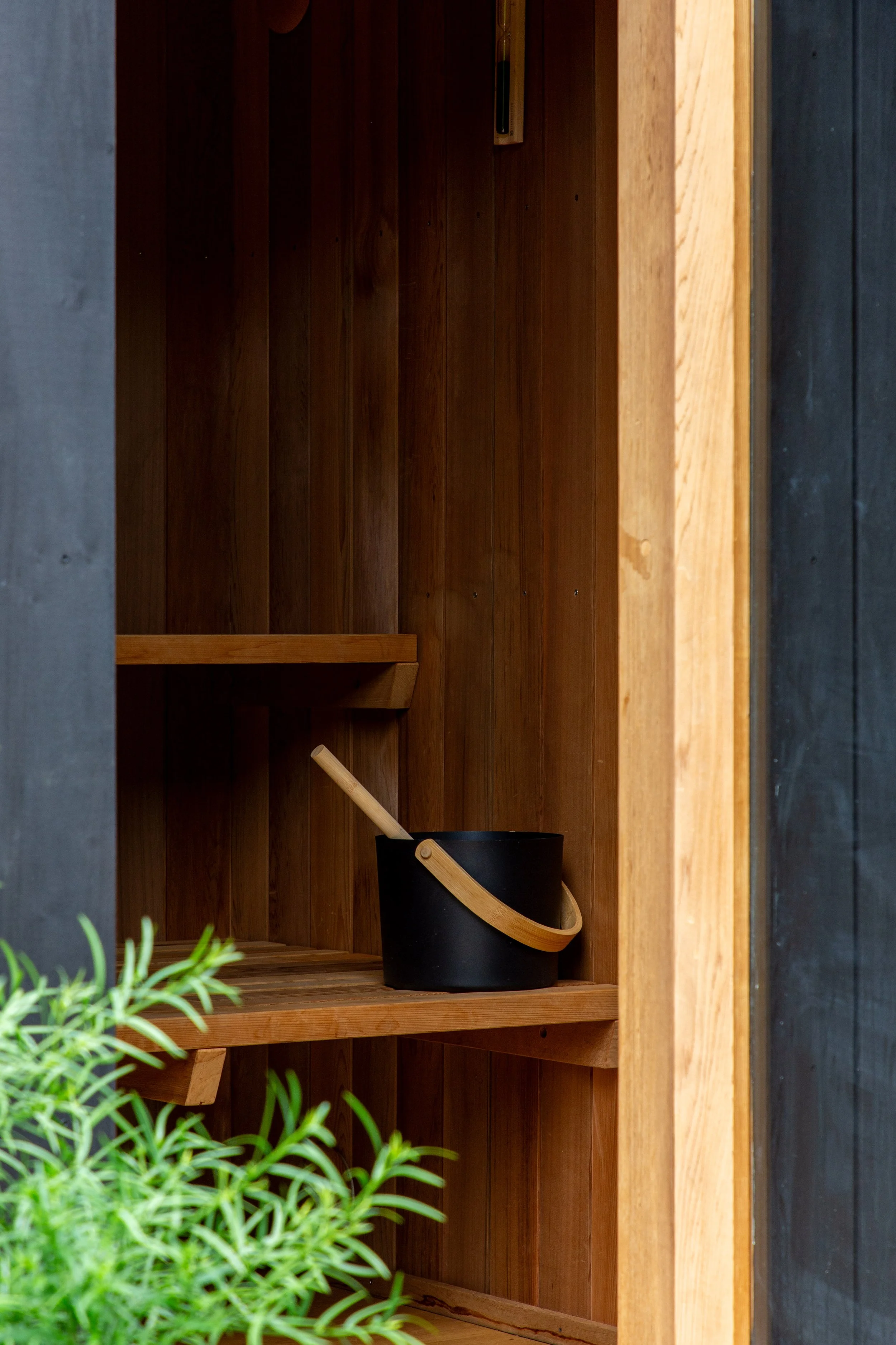 Cedar sauna interior with bench seating inside a bespoke outdoor sauna