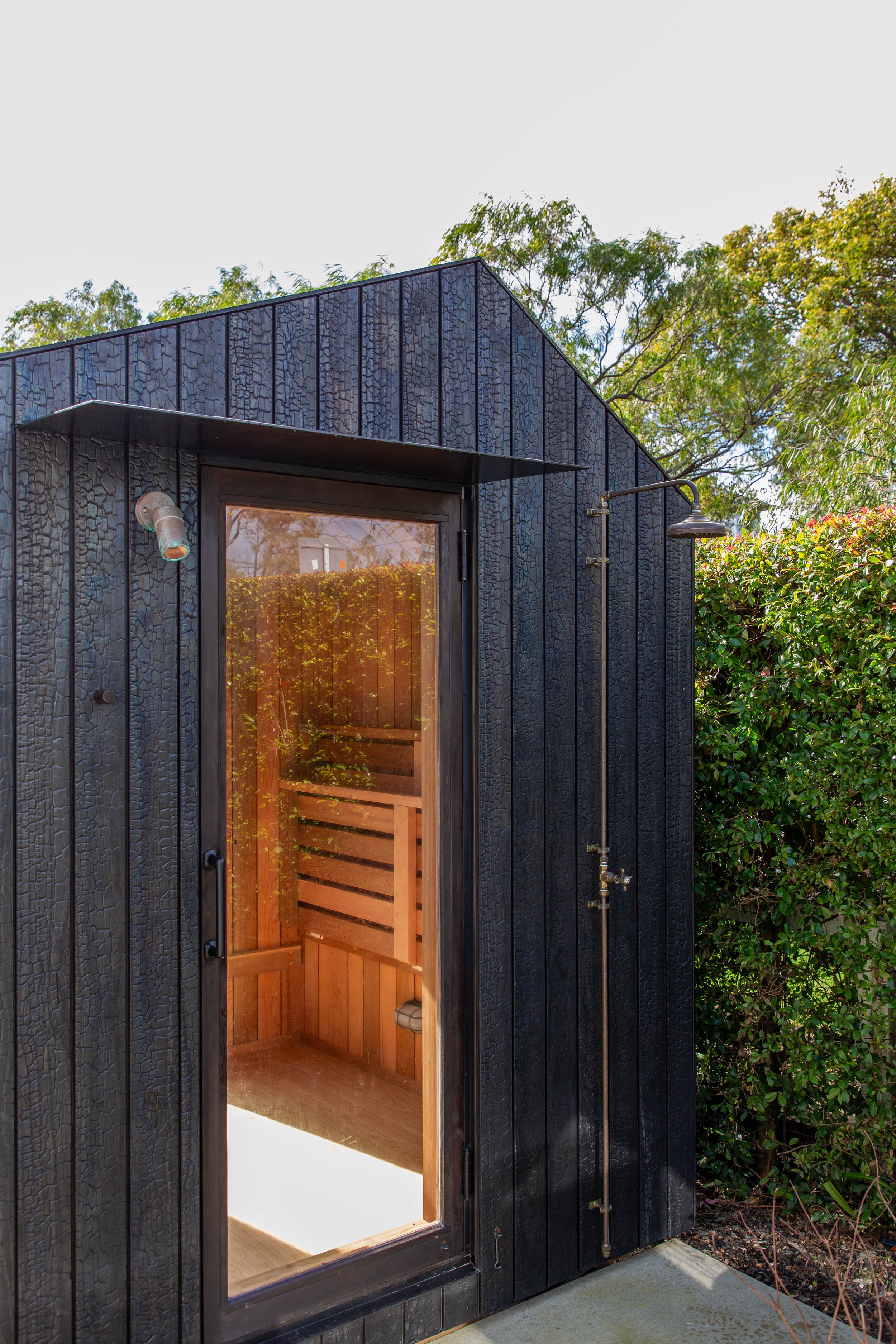 Six person sauna with hinged two tier solid bench seats to make room for yoga stretching