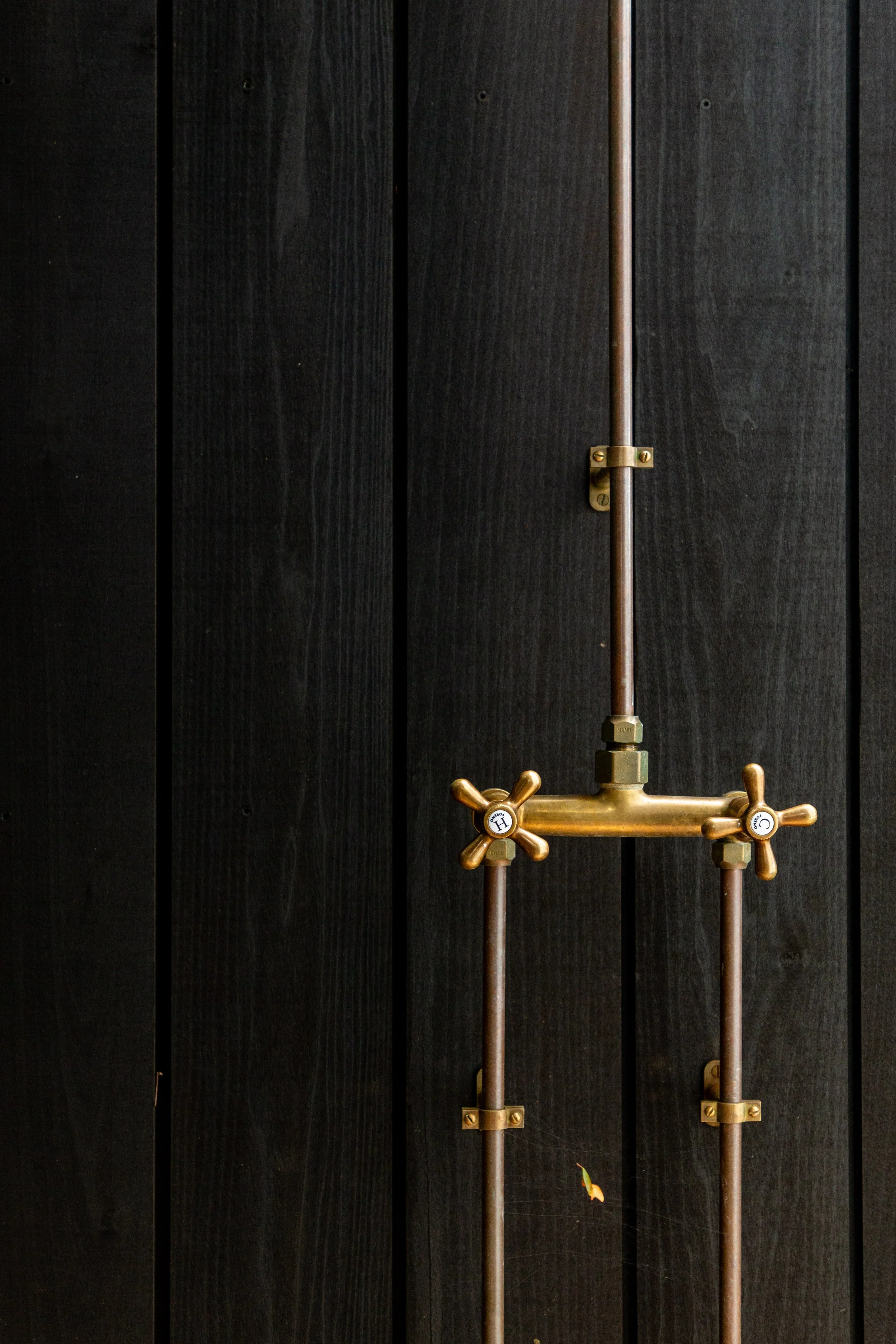 Showcasing Abodo Nero thermally modified timber cladding and Copper Outdoor Shower